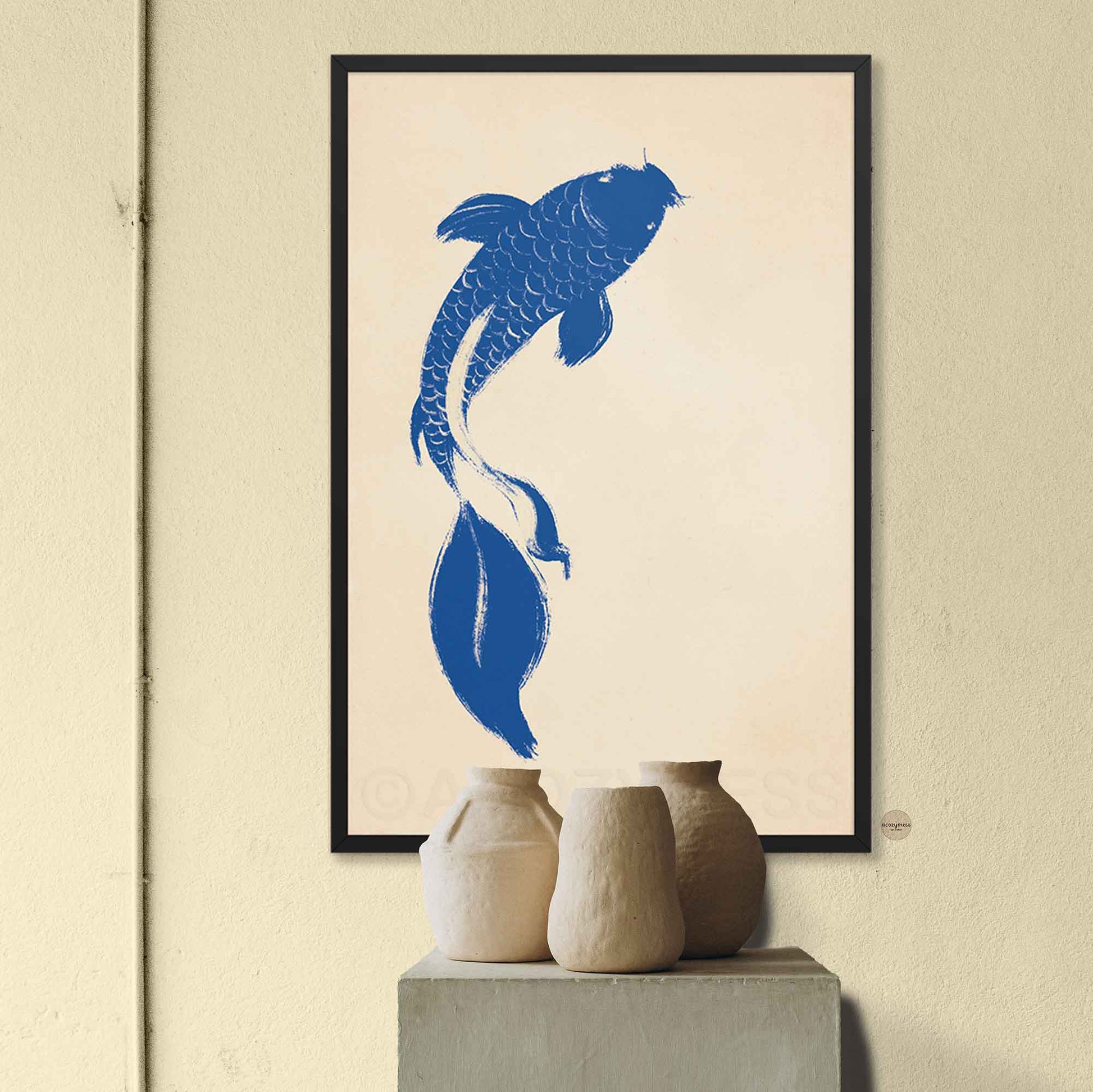  Blue koi fish art print on beige background shown in a sleek black frame for a bold, modern look.