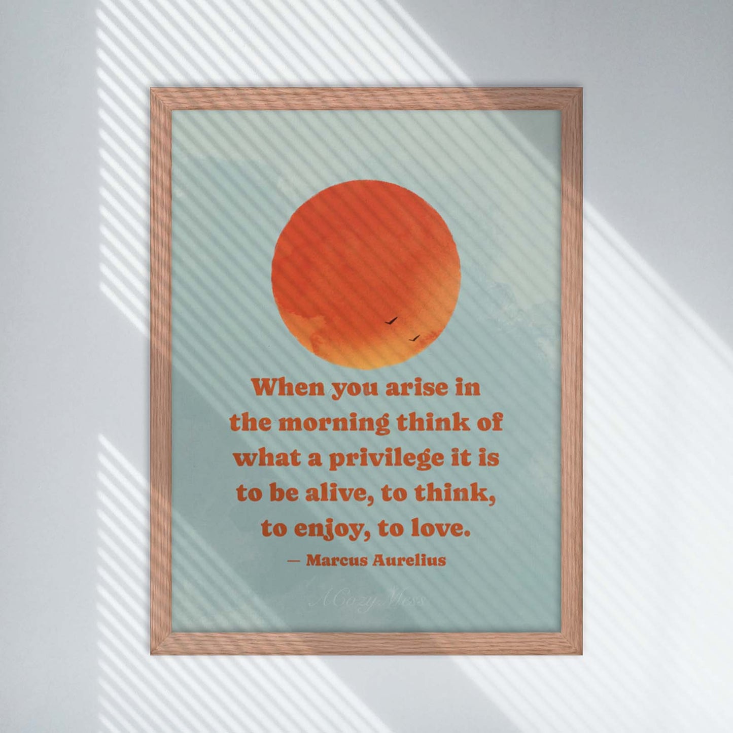 Stoic Art poster depicting a brilliant orange sun rising in a blue sky, accompanied by a quote by Marcus Aurelius that reads: 'When you arise in the morning, think of what a precious privilege it is to be alive - to breathe, to think, to enjoy, to love. Available in oak frame.