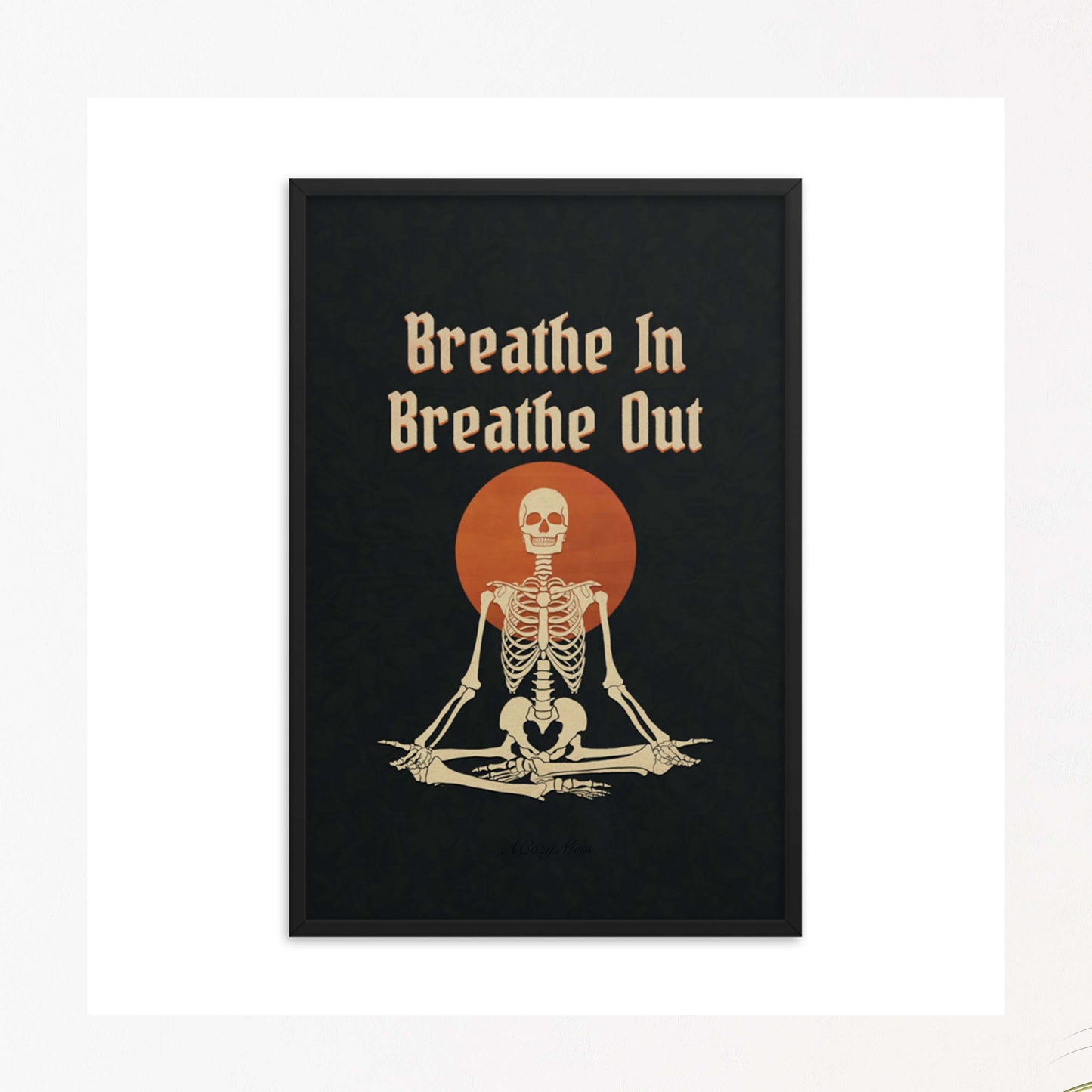 " Breathe in breathe Out" with an illustration of a meditating skeleton in beige and orange on black background