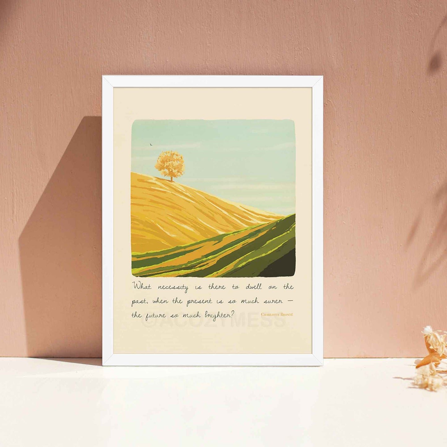  A landscape wall art print featuring an inspiring quote by Charlotte Brontë, the artwork includes a peaceful illustration of a bright mountain landscape, symbolizing optimism, growth, and a forward-looking mindset, displayed in white frame.