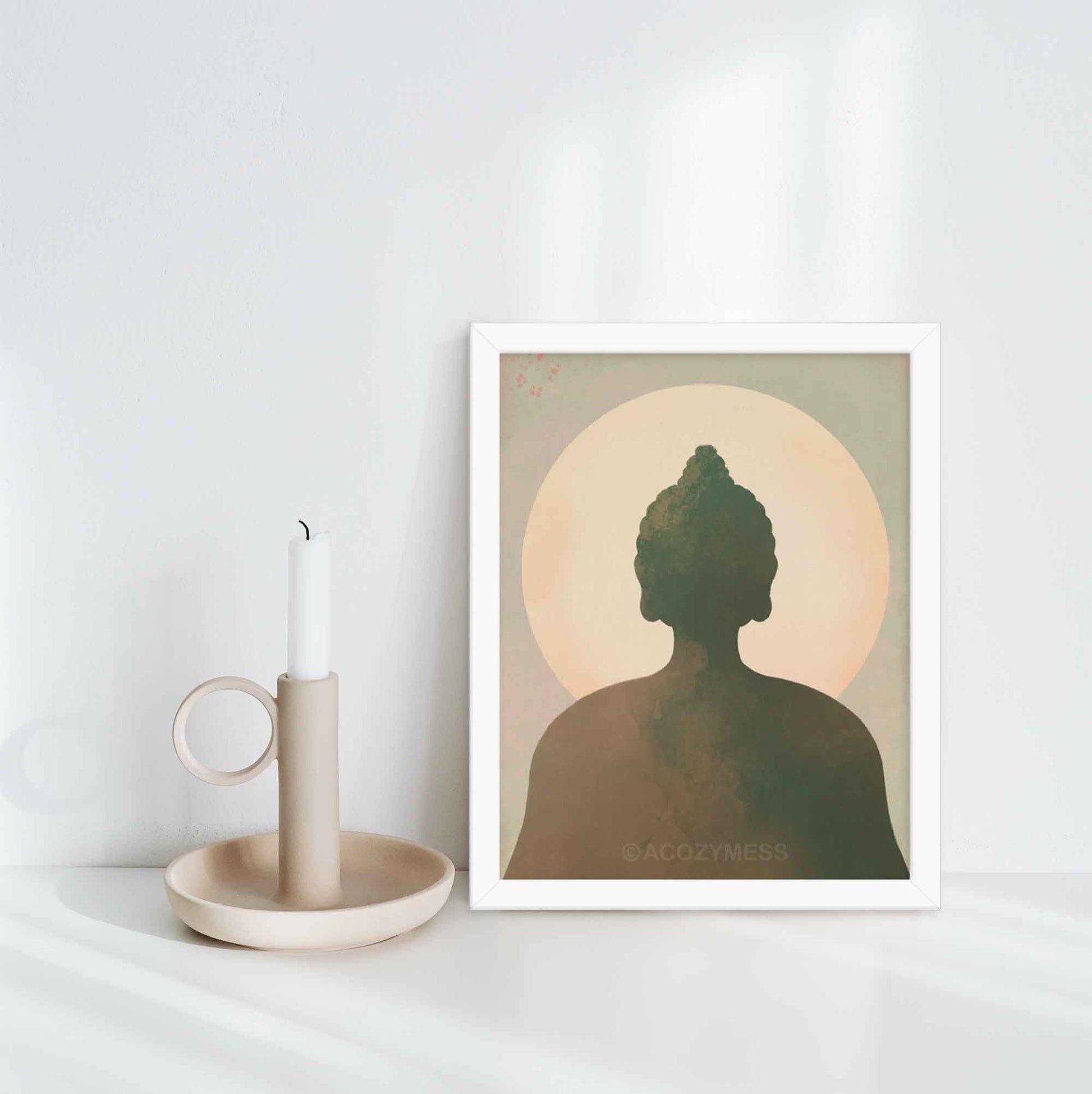 Buddha wall art in earthy tones of blue, green, brown, and beige, designed to bring tranquility and spiritual serenity to any space, in white frame.