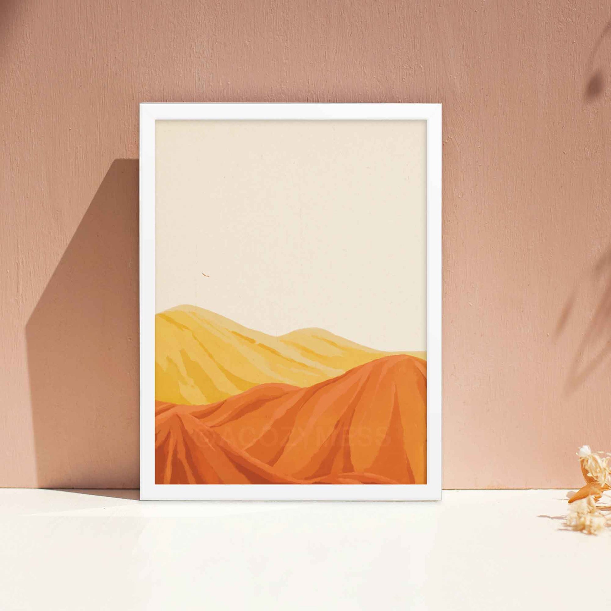 Desert mountain landscape artwork in warm yellow, orange, and brown tones with a beige background, in white frame