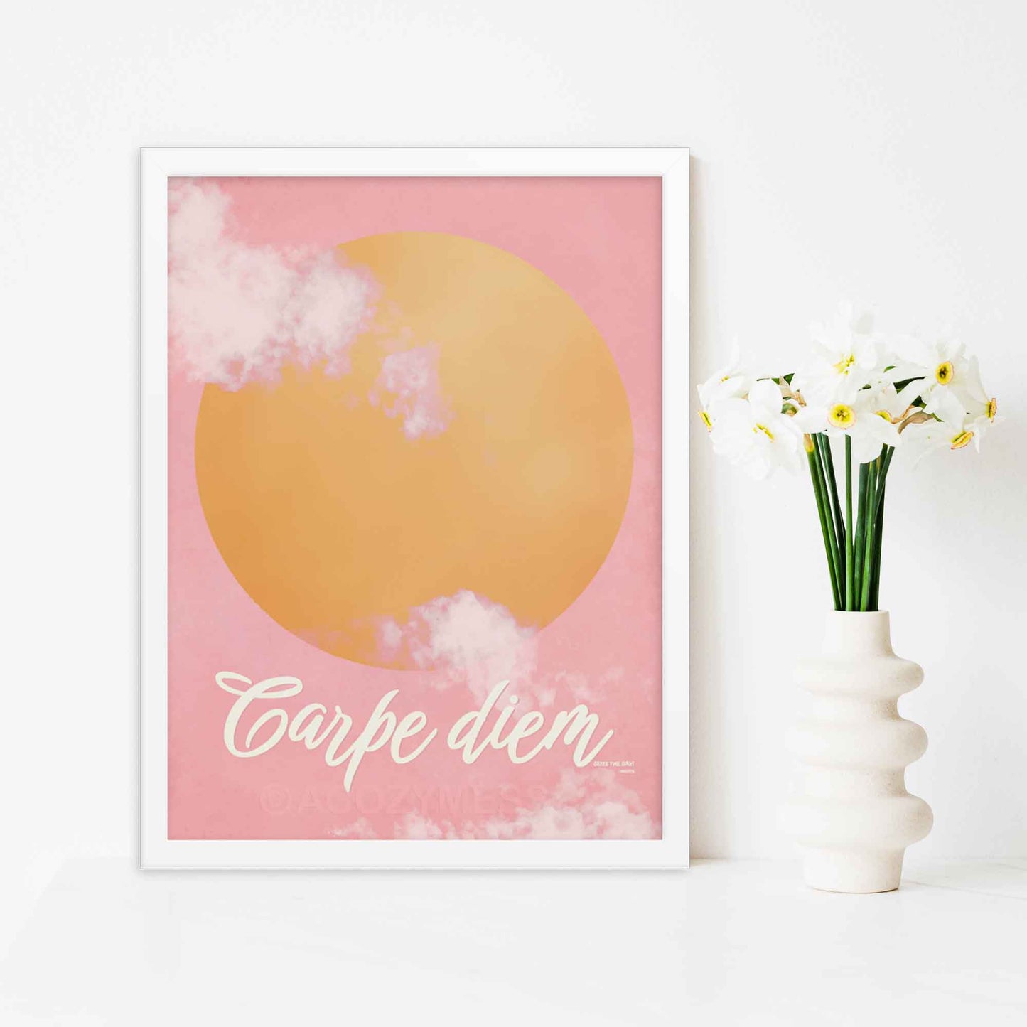 "Carpe Diem poster featuring a pink sky with soft clouds and a bright yellow sun, designed to inspire and uplift with the message 'Seize the Day.'" in white frame