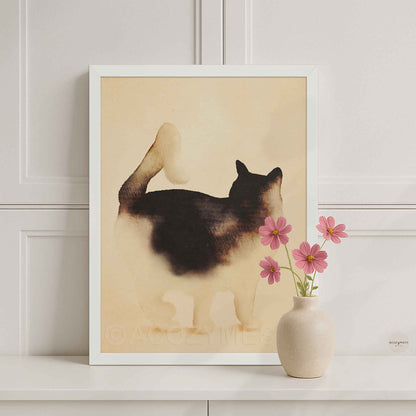 White framed minimalist standing cat poster on a white console with a pink flower vase in a bright room