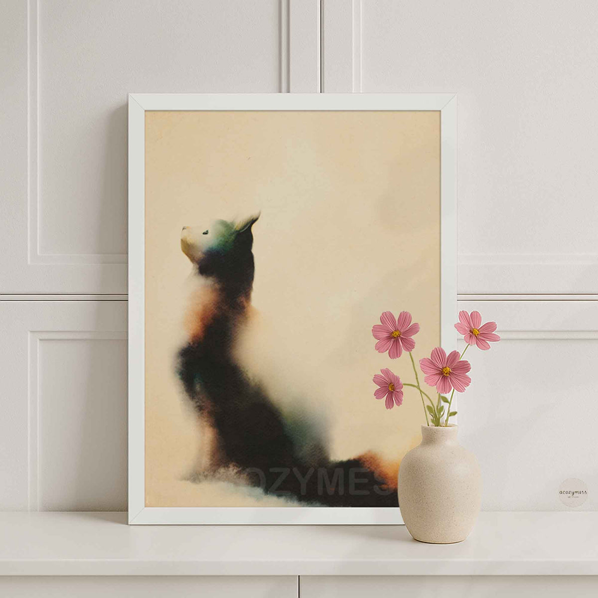 White framed sitting cat art print on a white console with a pink flower vase against white wall paneling