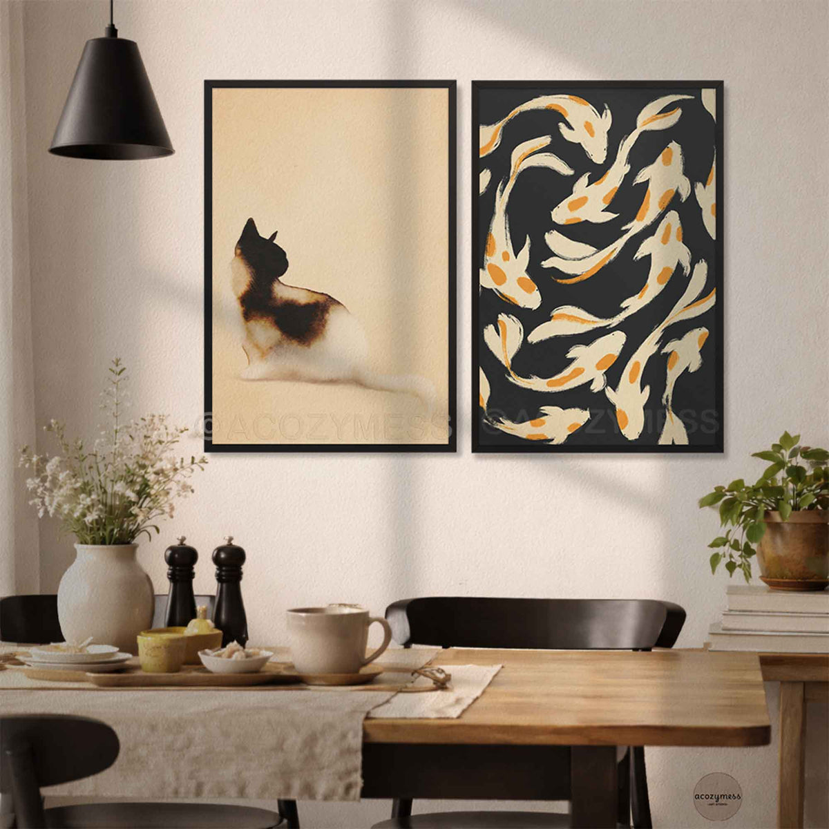 Black framed cat art print paired with a koi fish poster above a dining table in a modern kitchen