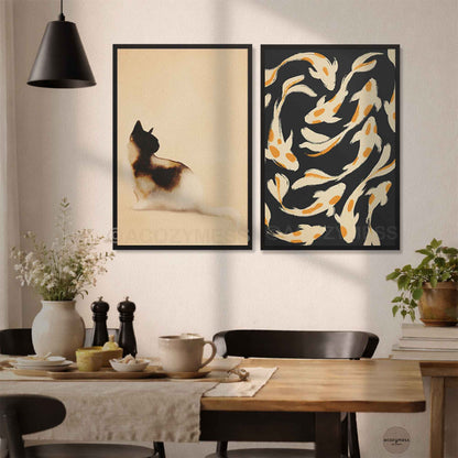Black framed cat art print paired with a koi fish poster above a dining table in a modern kitchen