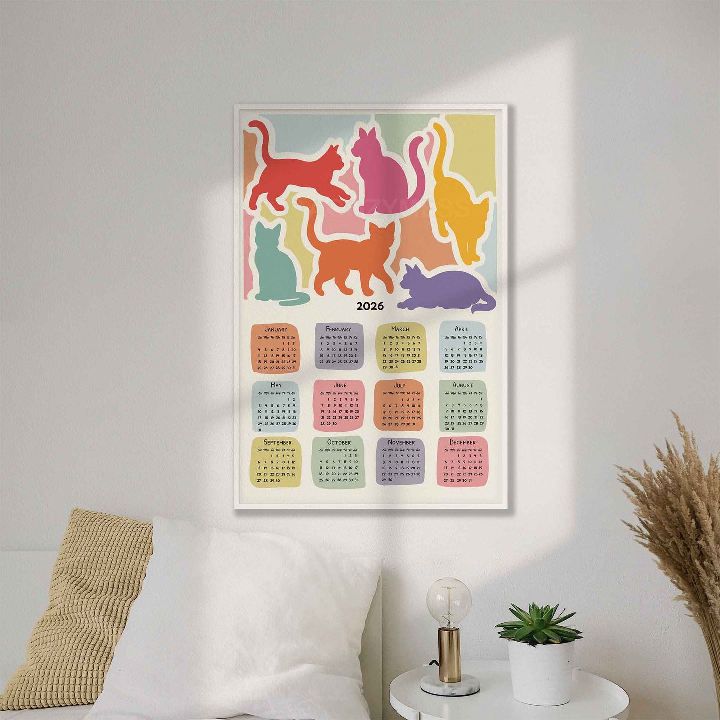 Colorful cat-themed calendar on a wall 