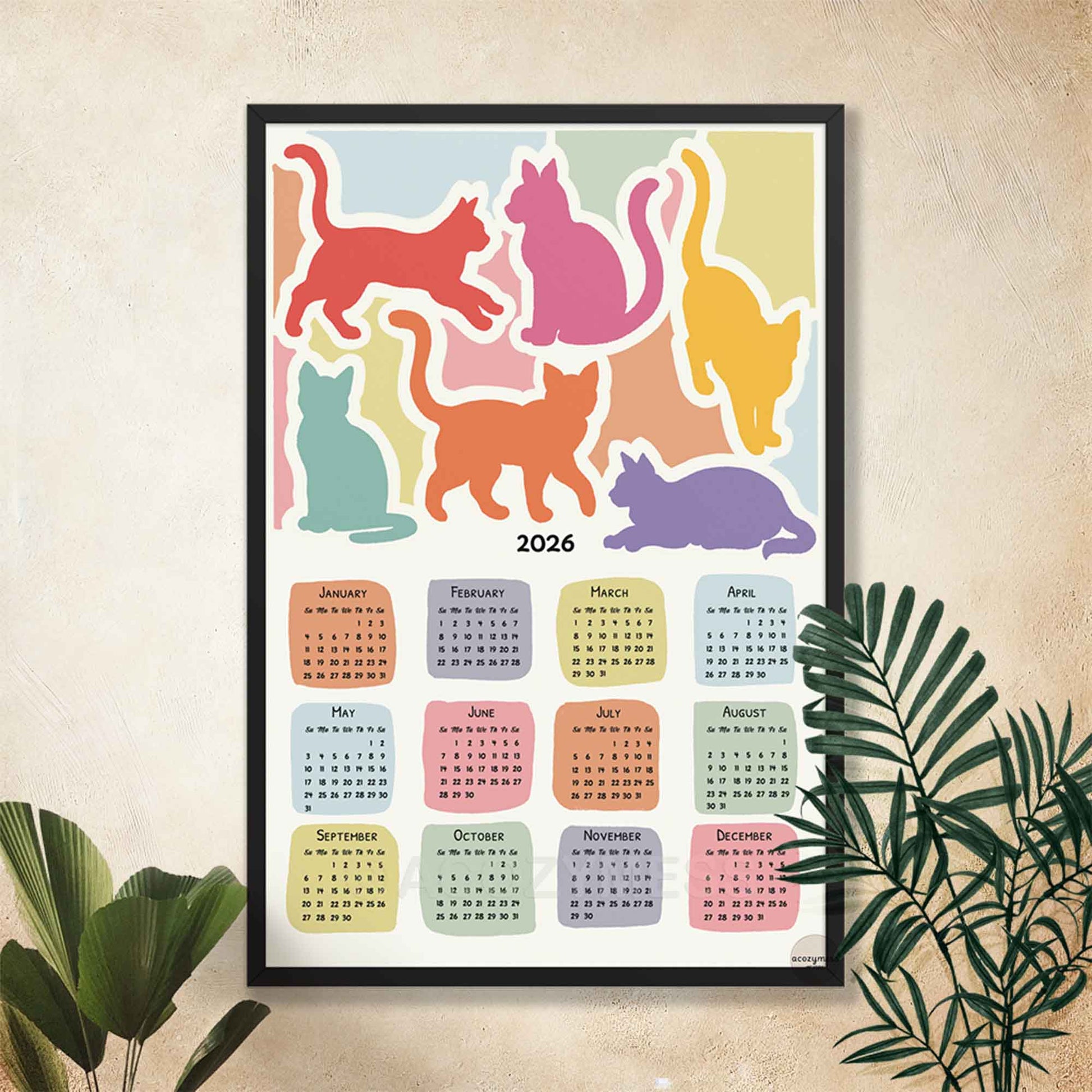 Colorful calendar with cat illustrations for 2026 on a wall 