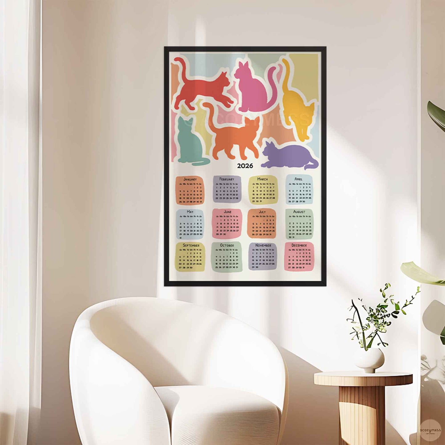 Colorful cat-themed calendar on a wall in a modern living room.