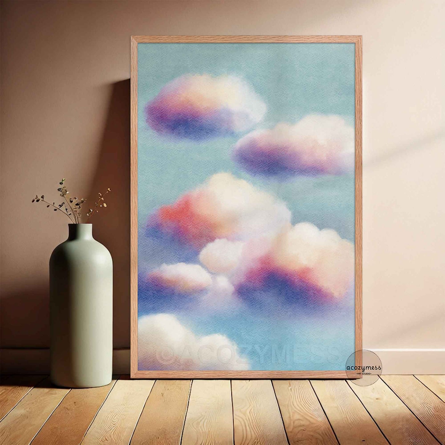 Framed artwork of colorful clouds on a wall next to a vase.