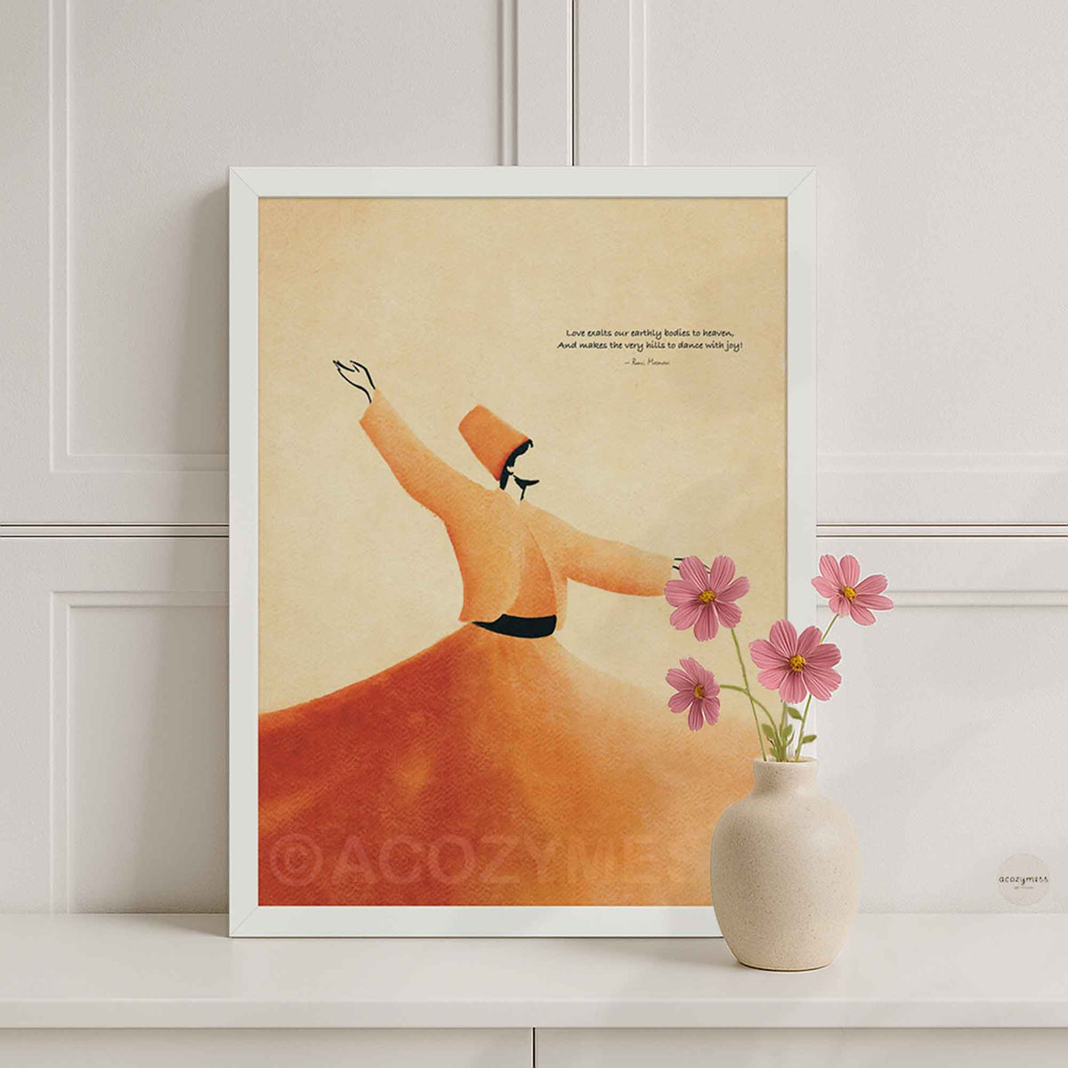White framed Sufi dervish Rumi quote print on a white console with a pink flower vase in a bright room