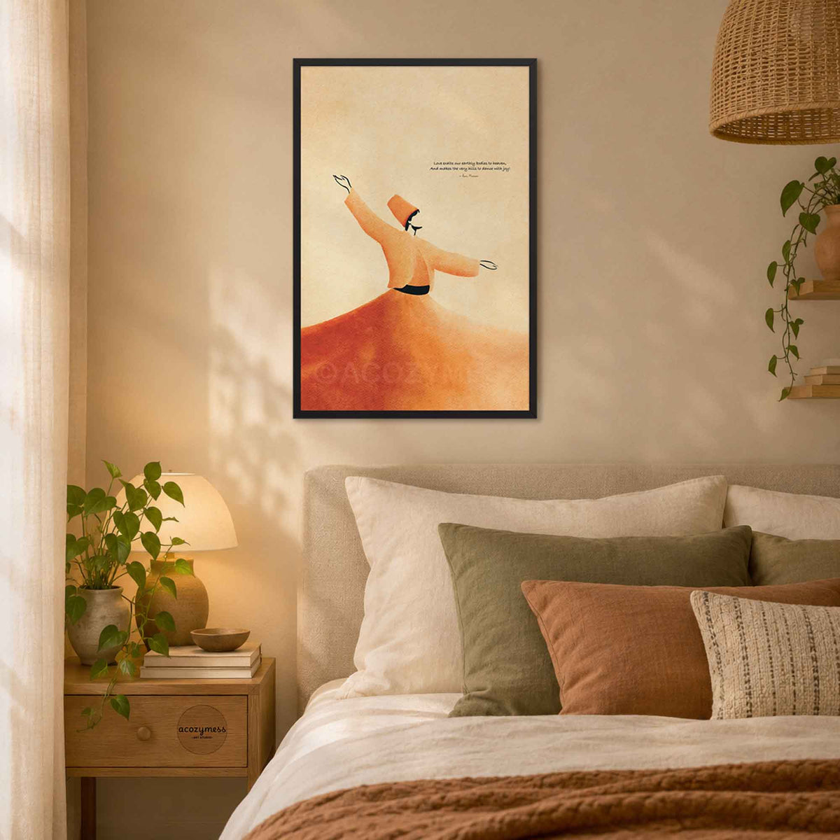 Black framed Rumi whirling dervish art print above a bed with soft pillows in a cozy bedroom