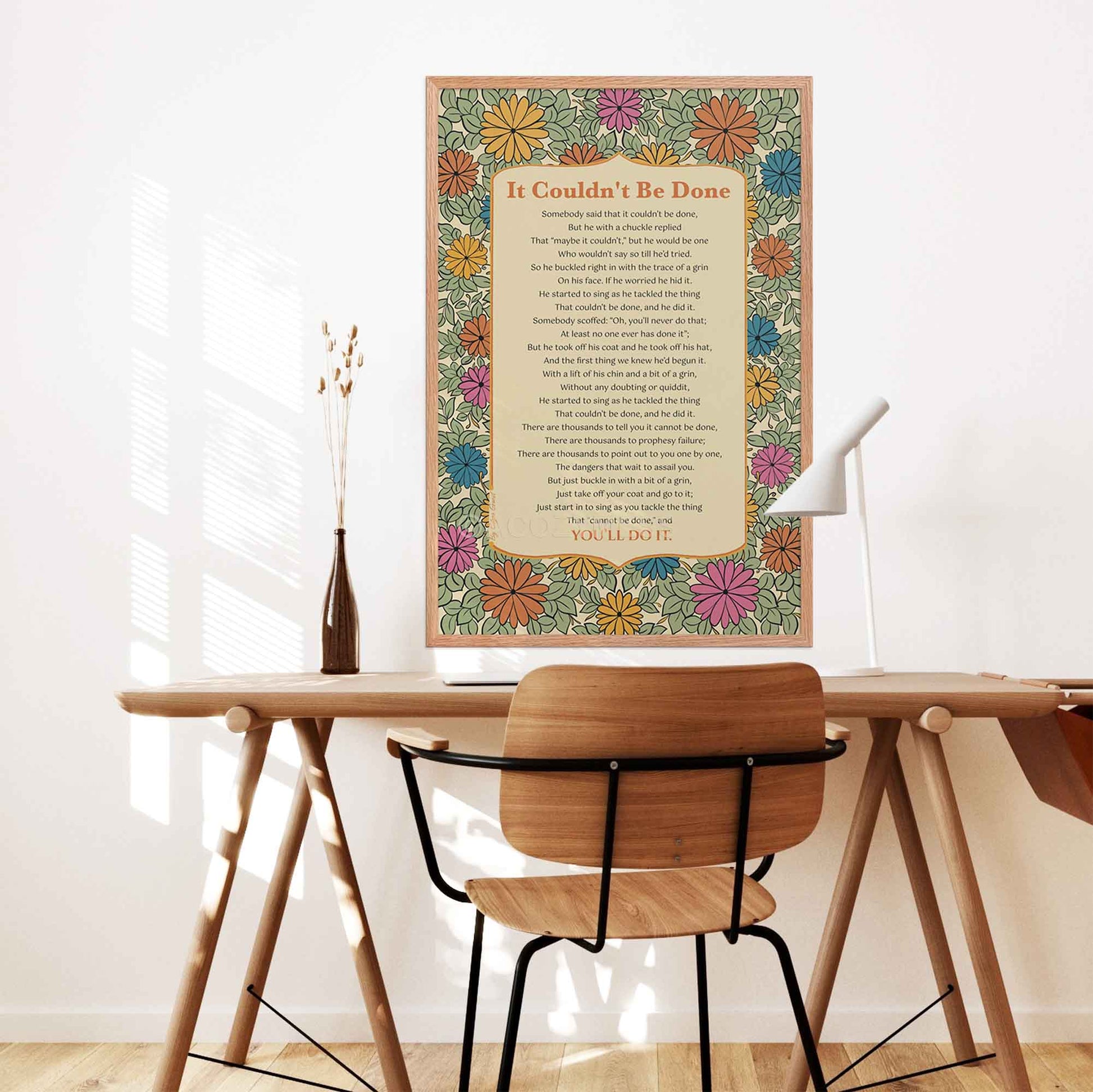 it couldn't be done poem by Edgar Guest Poem Poster with floral design in oakwood frame displayed on a desk wall.