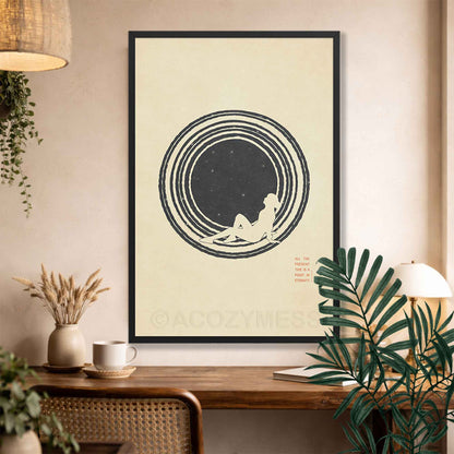 A black  minimalist philosophy poster featuring a clean illustration of a lone figure stargazing beneath a vast, starry sky. The artwork is framed in a sleek border, displaying sharp typography with the Marcus Aurelius quote: ALL THE PRESENT IS A POINT IN ETERNITY.