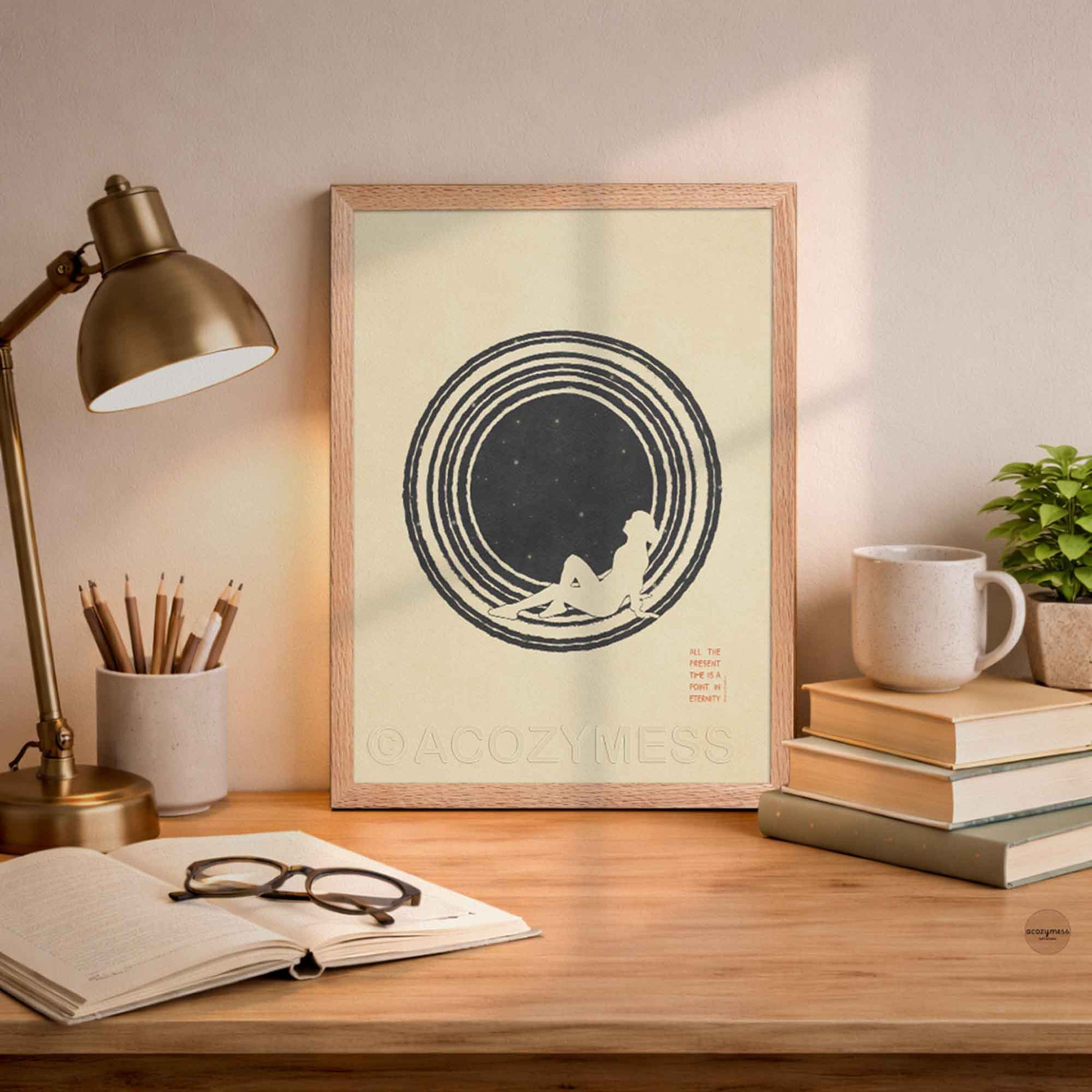 An oakwood framed  minimalist philosophy poster featuring a clean illustration of a lone figure stargazing beneath a vast, starry sky. The artwork is framed in a sleek border, displaying sharp typography with the Marcus Aurelius quote on present moment leaning on a desk .