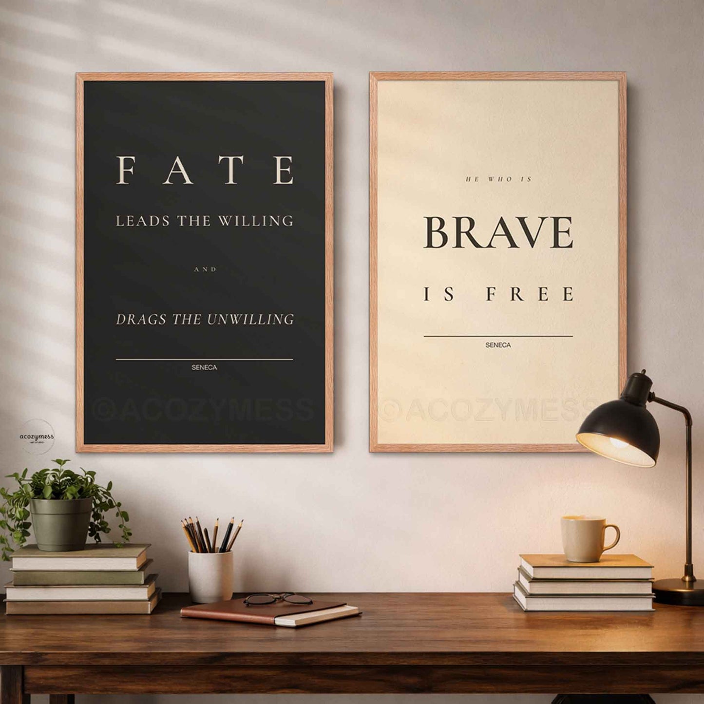 Two framed stoic quotes on a wall above a wooden desk with books and a lamp.
