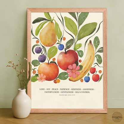 Fruit of the Spirit wall art displayed in an oakwood frame, featuring vibrant fruit illustrations and scripture-inspired text on beige.