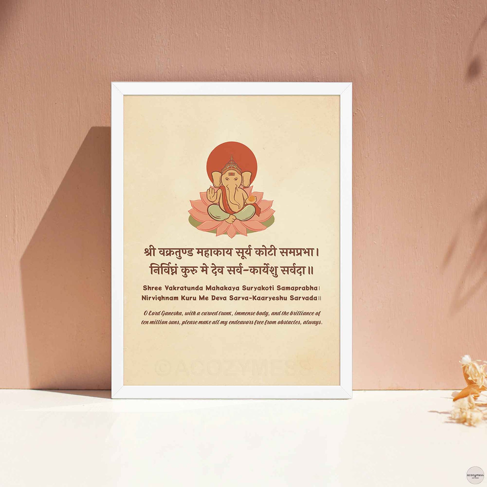 Framed Ganesha mantra wall art in white frame, featuring beige background with Sanskrit shloka and English translation, ideal for spiritual decor or meditation room display.