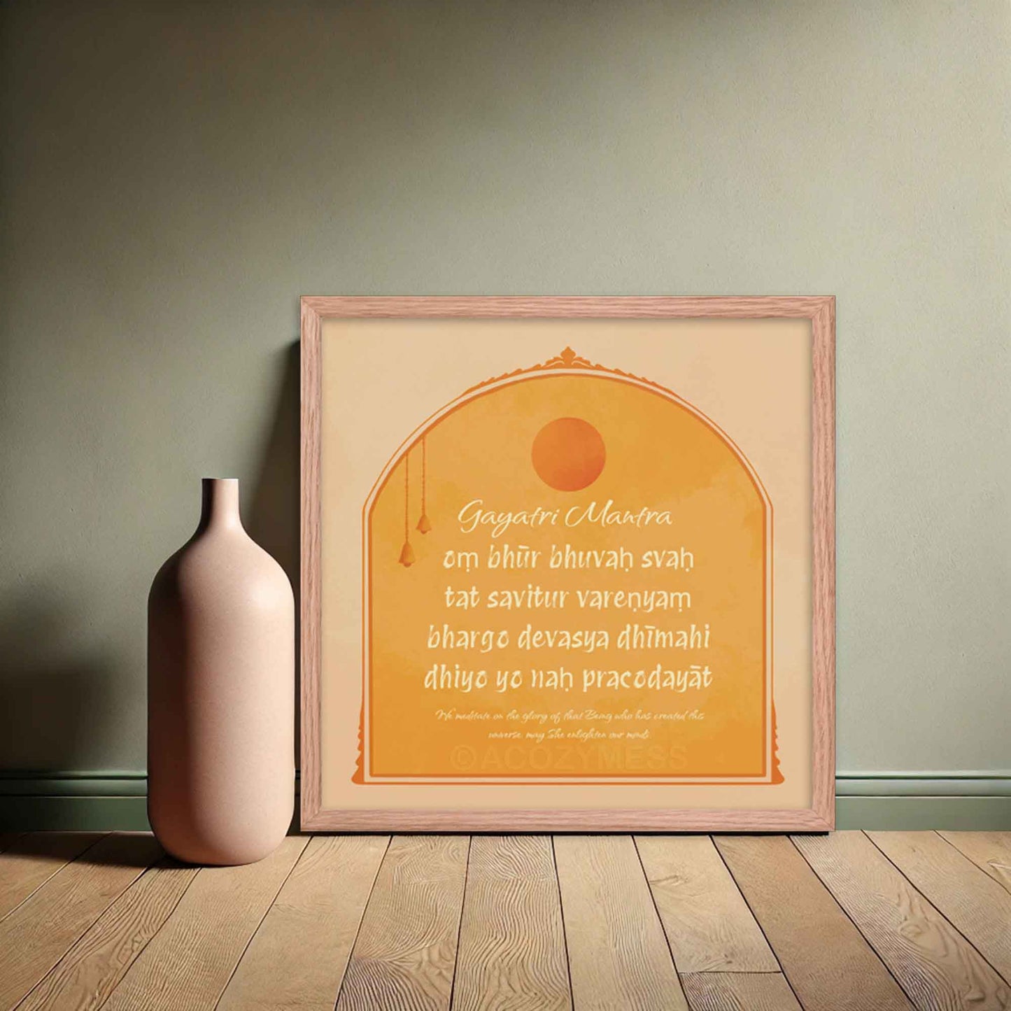 "Gayatri Mantra art print in yellow, beige, and orange colors, designed in square sizes to bring warmth and spiritual energy to any space." in oakwood frame.