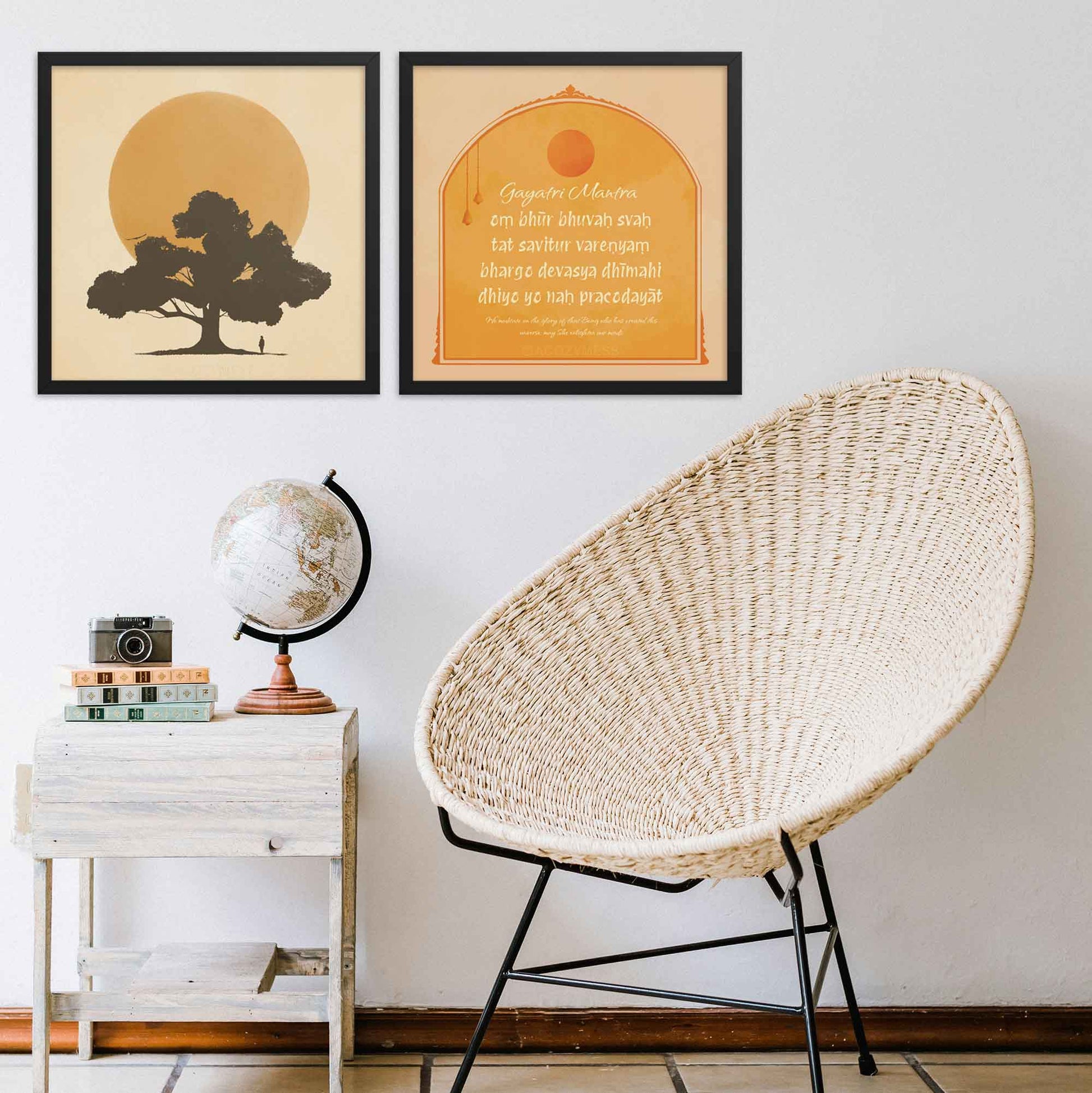 "Gayatri Mantra art print , and another art print of a huge sun and tree silhoutte", in yellow, beige, and orange colors, framed in black.