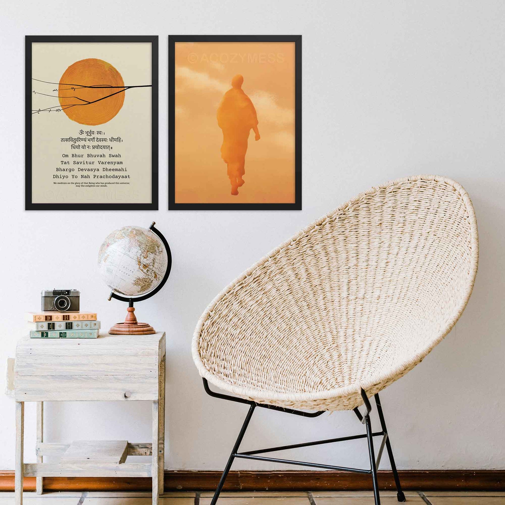 gayatri mantra sun art print and walking monk art print in orange, yellow and beige, both framed in black.