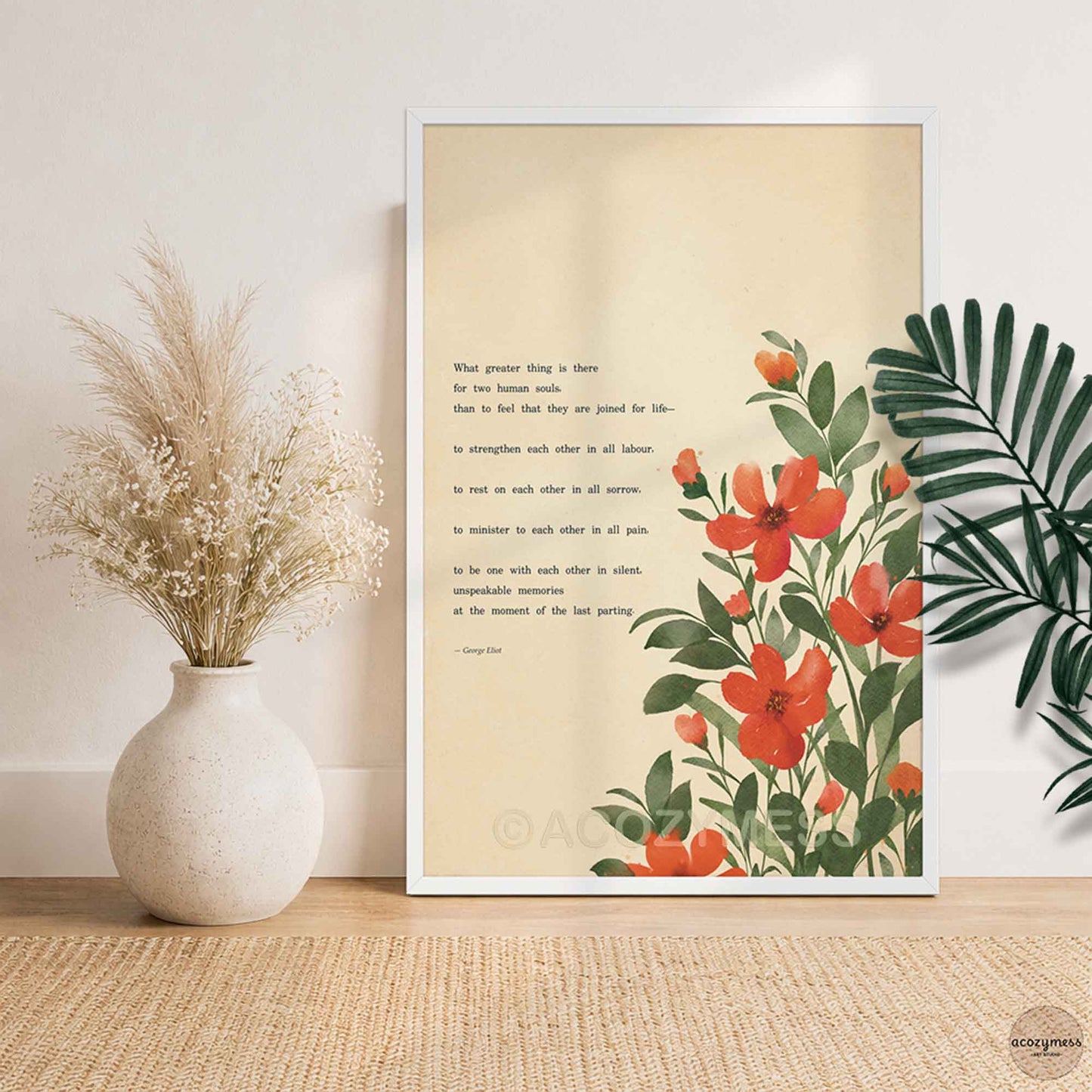 A white framed art print featuring a quote by George Eliot about love on a beige background with red-orange flowers and green leaves.