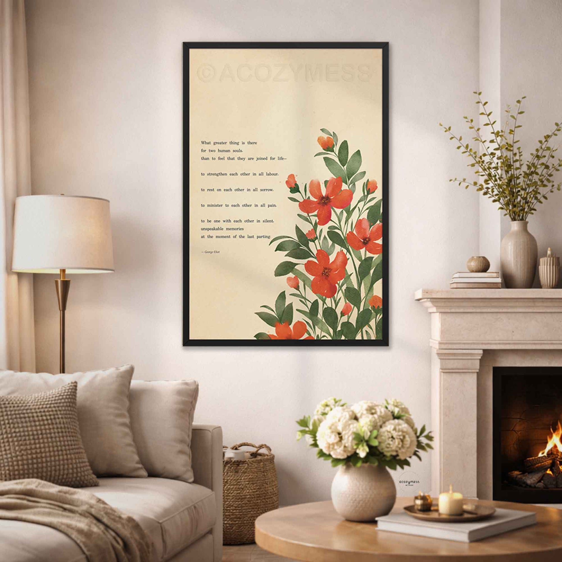 A framed vertical art print featuring red and orange flowers with green leaves and a romantic poem on a cream background, displayed on a wall in a cozy living room setting.