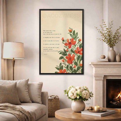 A framed vertical art print featuring red and orange flowers with green leaves and a romantic poem on a cream background, displayed on a wall in a cozy living room setting.