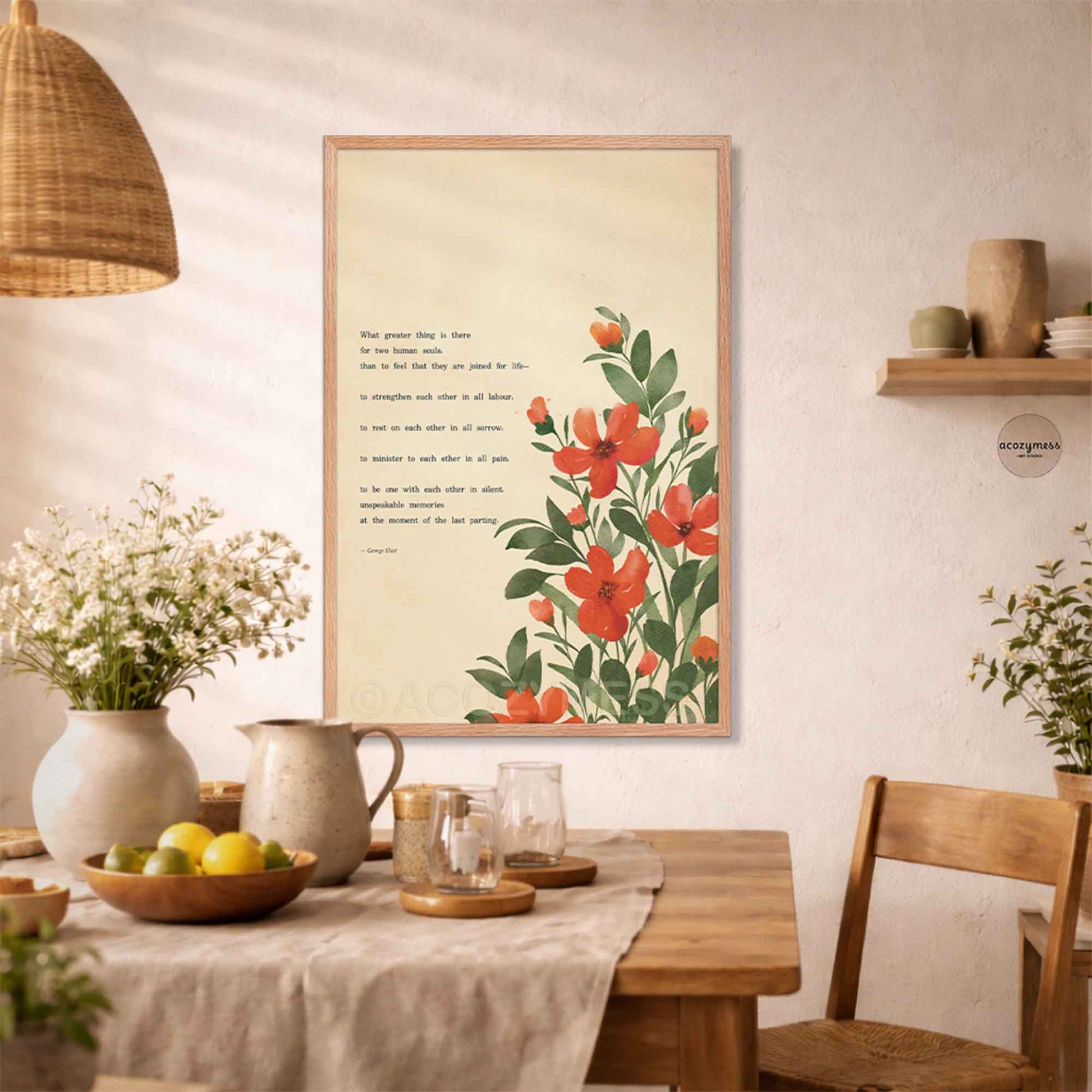 A framed art print featuring a botanical illustration of red flowers with green leaves on a cream background, alongside a quote by George Eliot. 