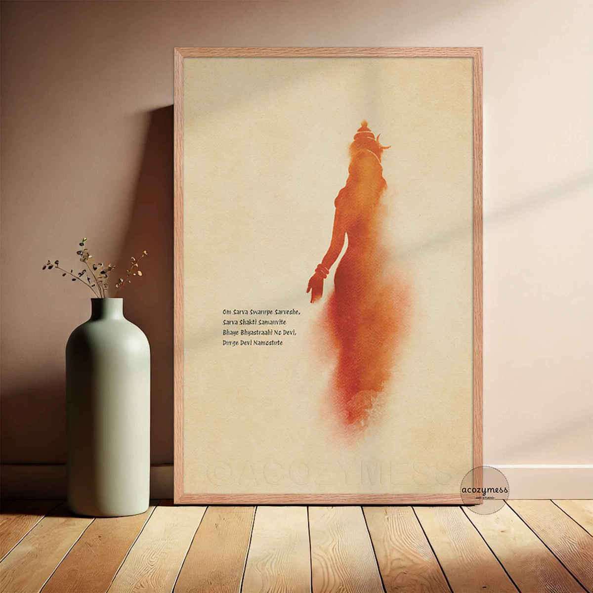 A framed art print featuring a stylized orange-red silhouette of maa durga and sanskrit mantra  on a warm beige background,