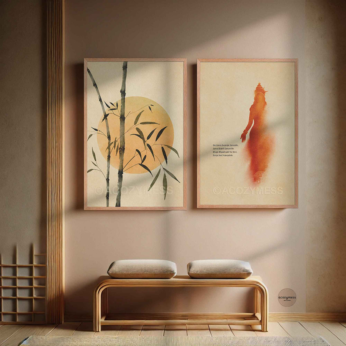Two framed wall art prints hang above a wooden bench in a styled interior.