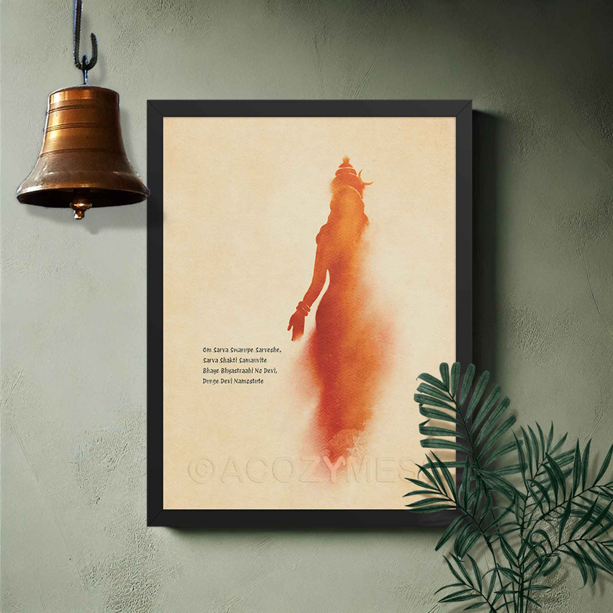 A blackframed art print featuring a stylized orange-red silhouette of goddess on a warm beige background,