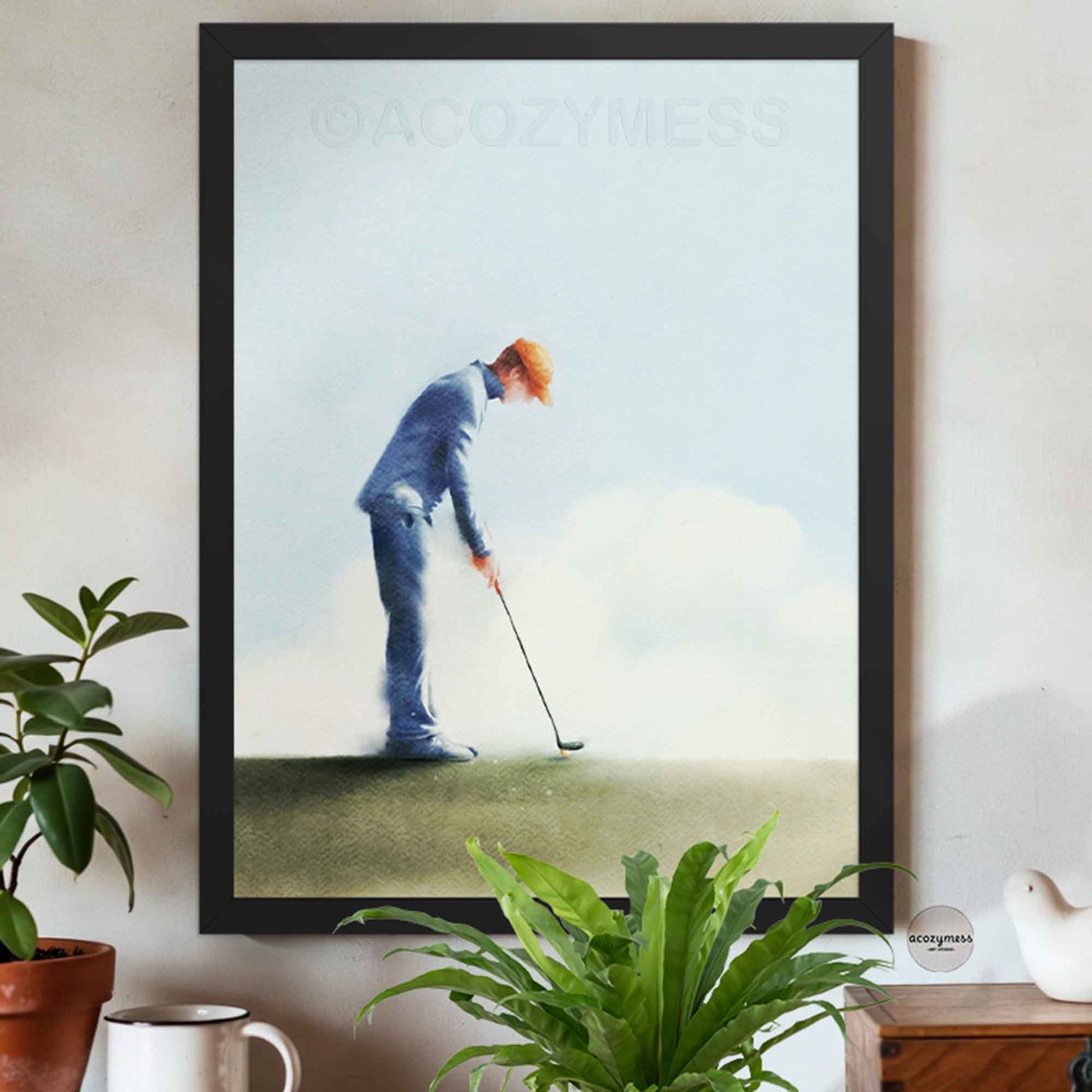 Black Framed artwork of a person playing golf on a wall.