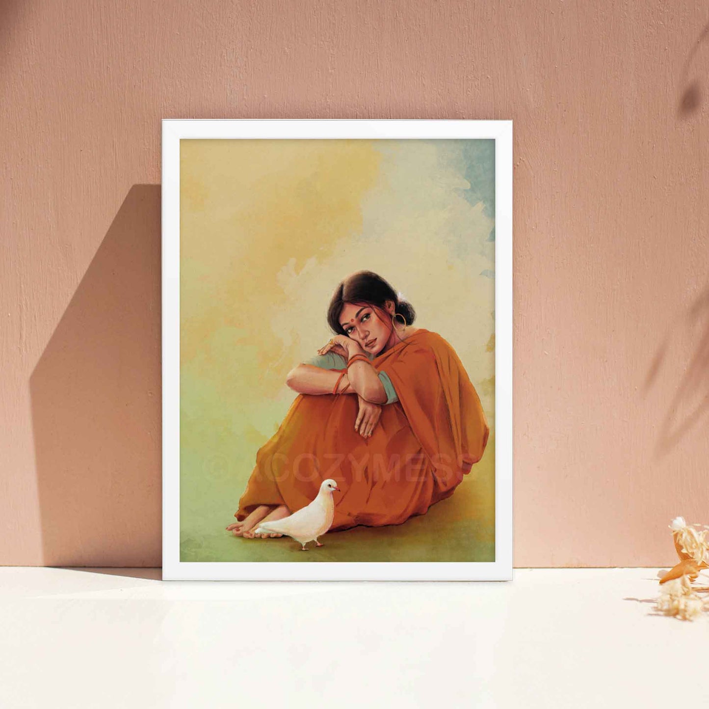 Indian woman sitting in a red saree with white dove wall art poster in white frame.