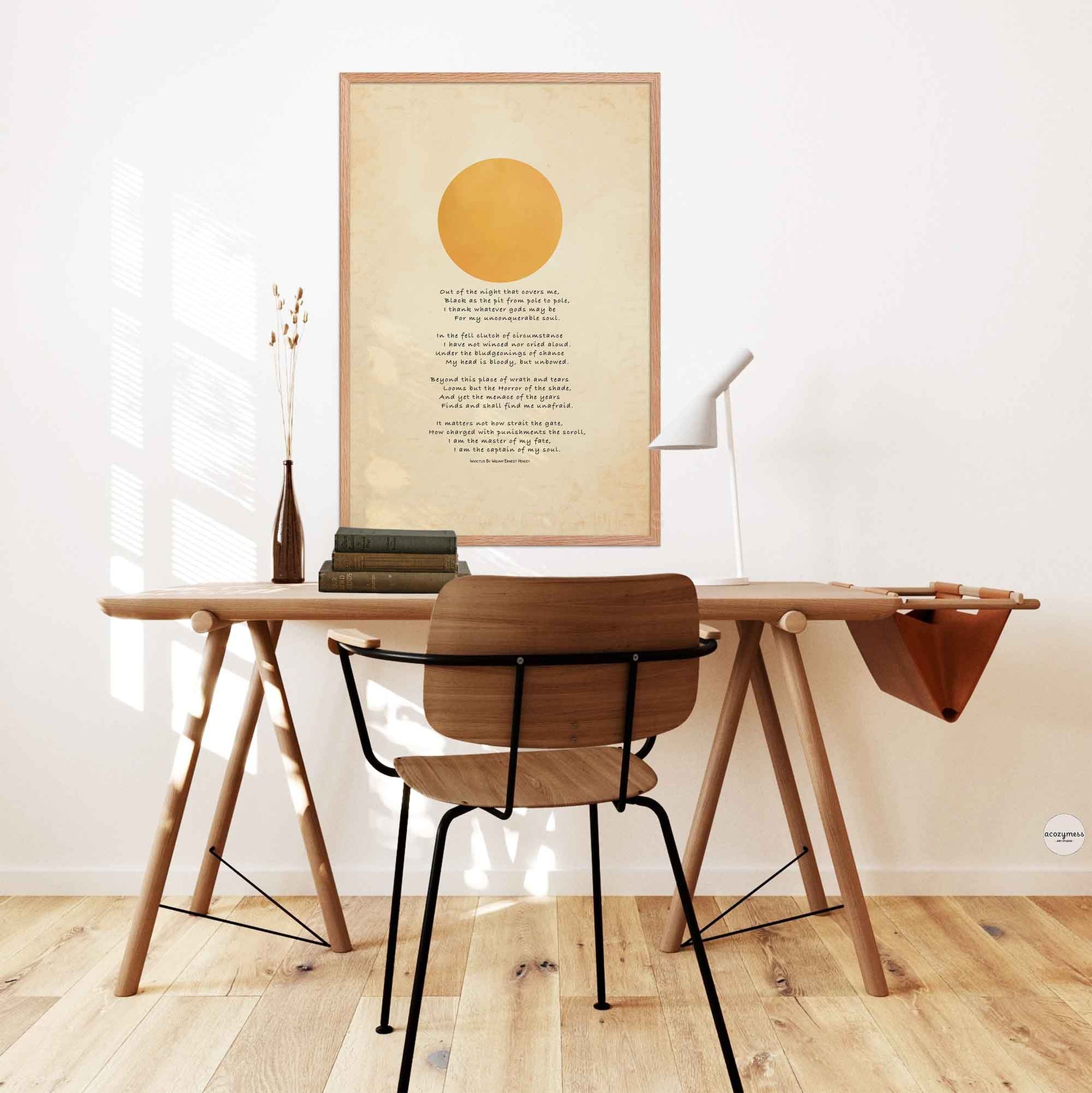 Invictus Poster displayed in an oakwood frame, styled on a study desk wall
