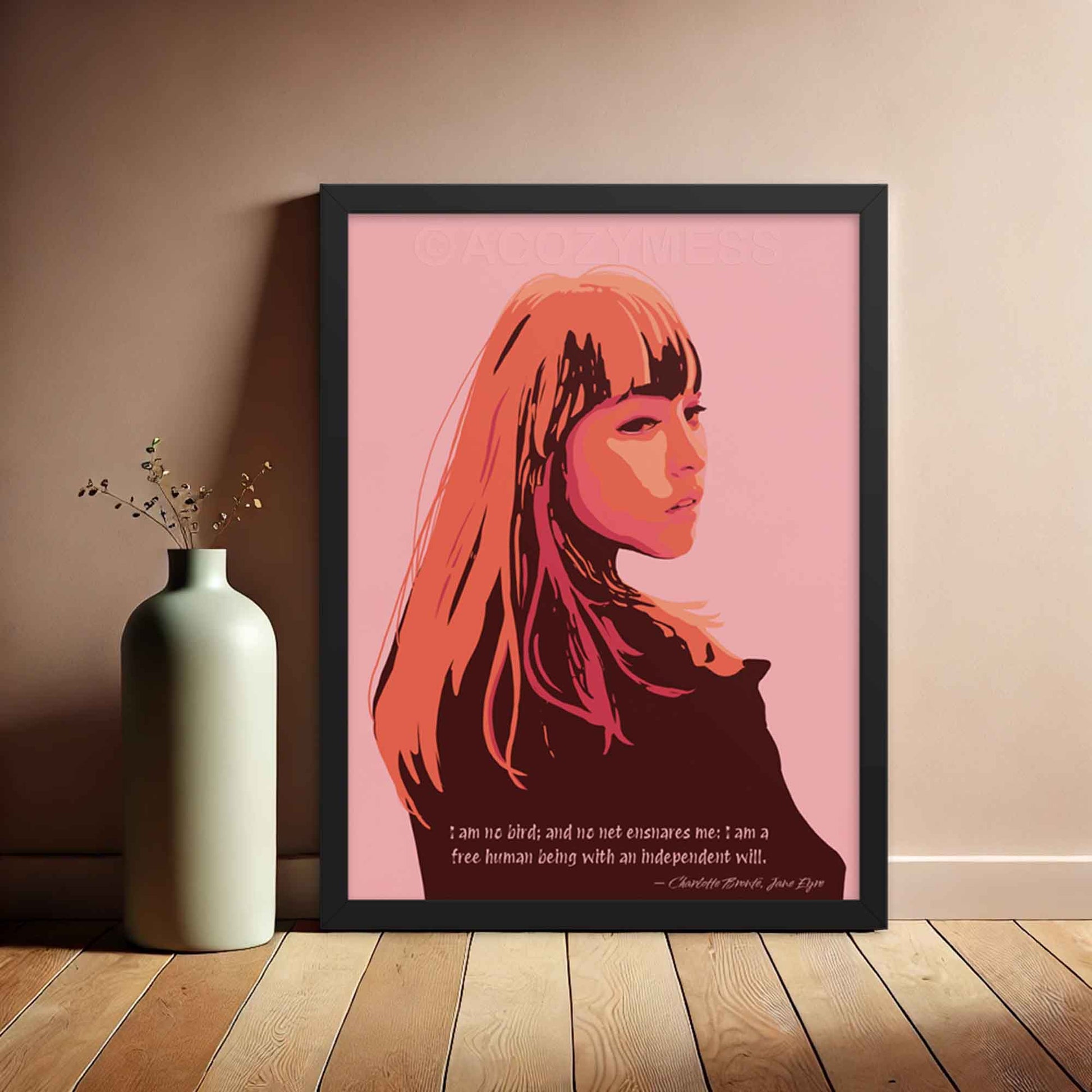 Pink Wall Art print of a woman in pink, orange, and brown tones with a quote from Jane Eyre , I am no bird; and no net ensnares me; I am a free human being, with an independent will, in black frame