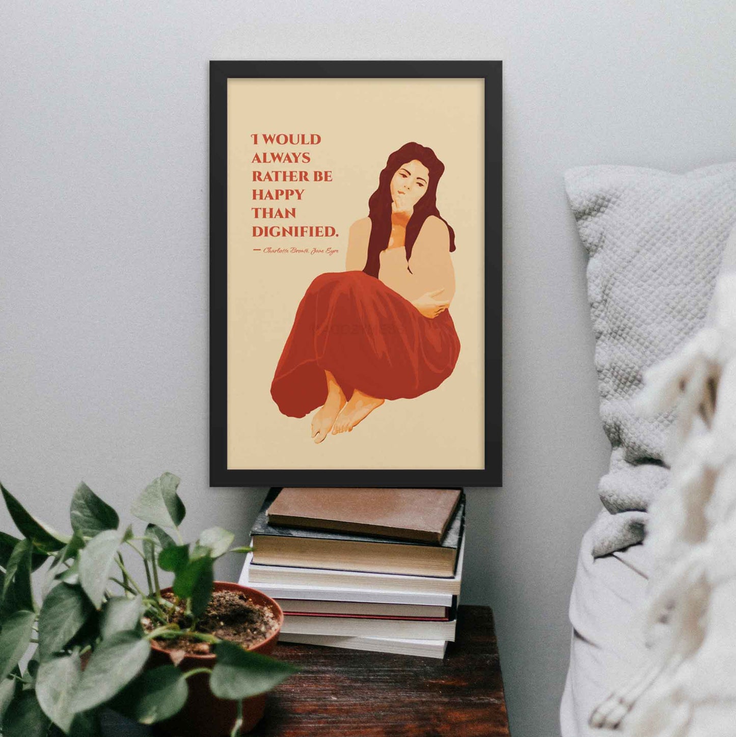 Art print featuring a woman illustration with the quote from Jane Eyre: 'I would always rather be happy than dignified,' designed in red and beige color hues in black frame