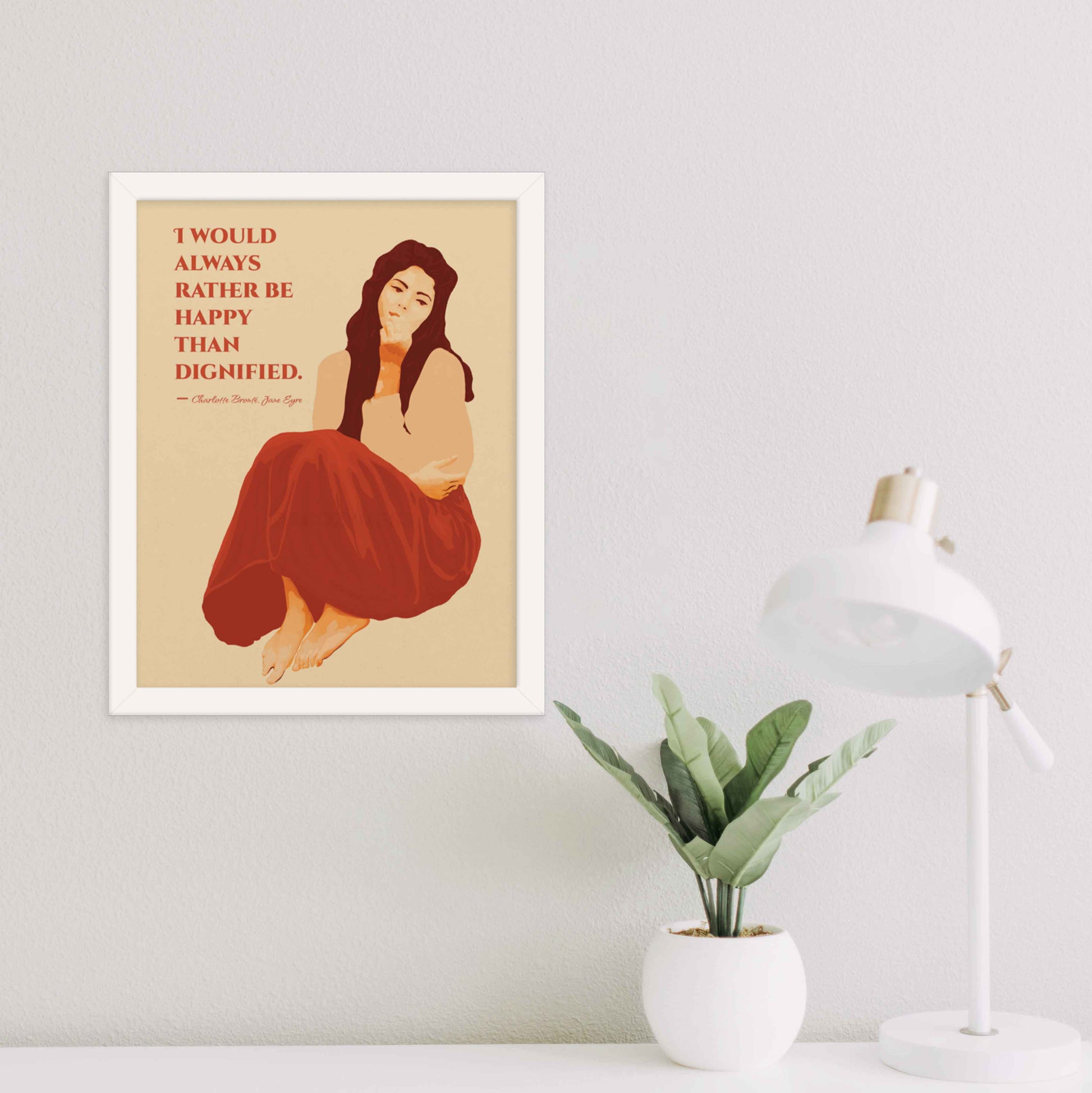 Art print featuring a woman illustration with the quote from Jane Eyre: 'I would always rather be happy than dignified,' designed in red and beige color hues in white frame