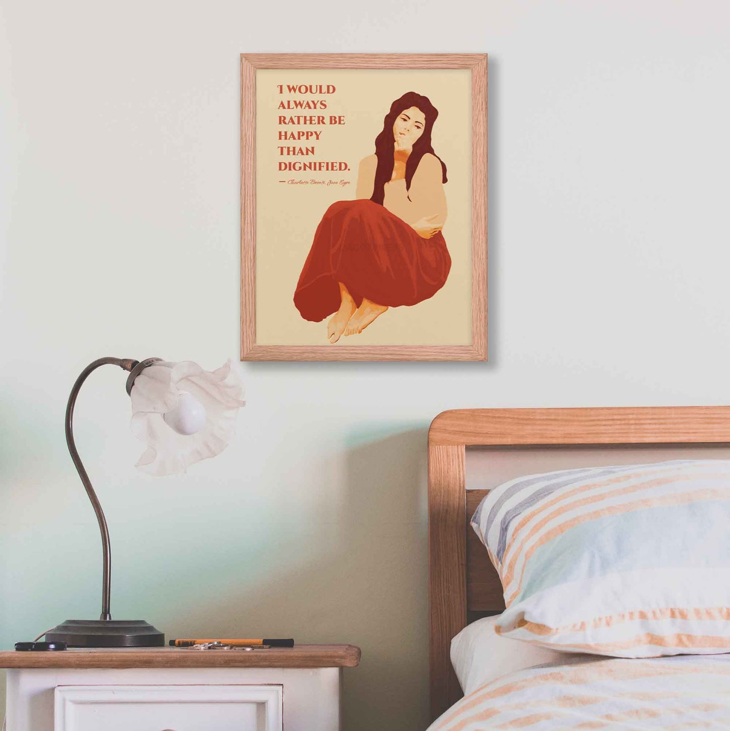 Art print featuring a woman illustration with the quote from Jane Eyre: 'I would always rather be happy than dignified,' designed in red and beige color hues, framed in oakwood