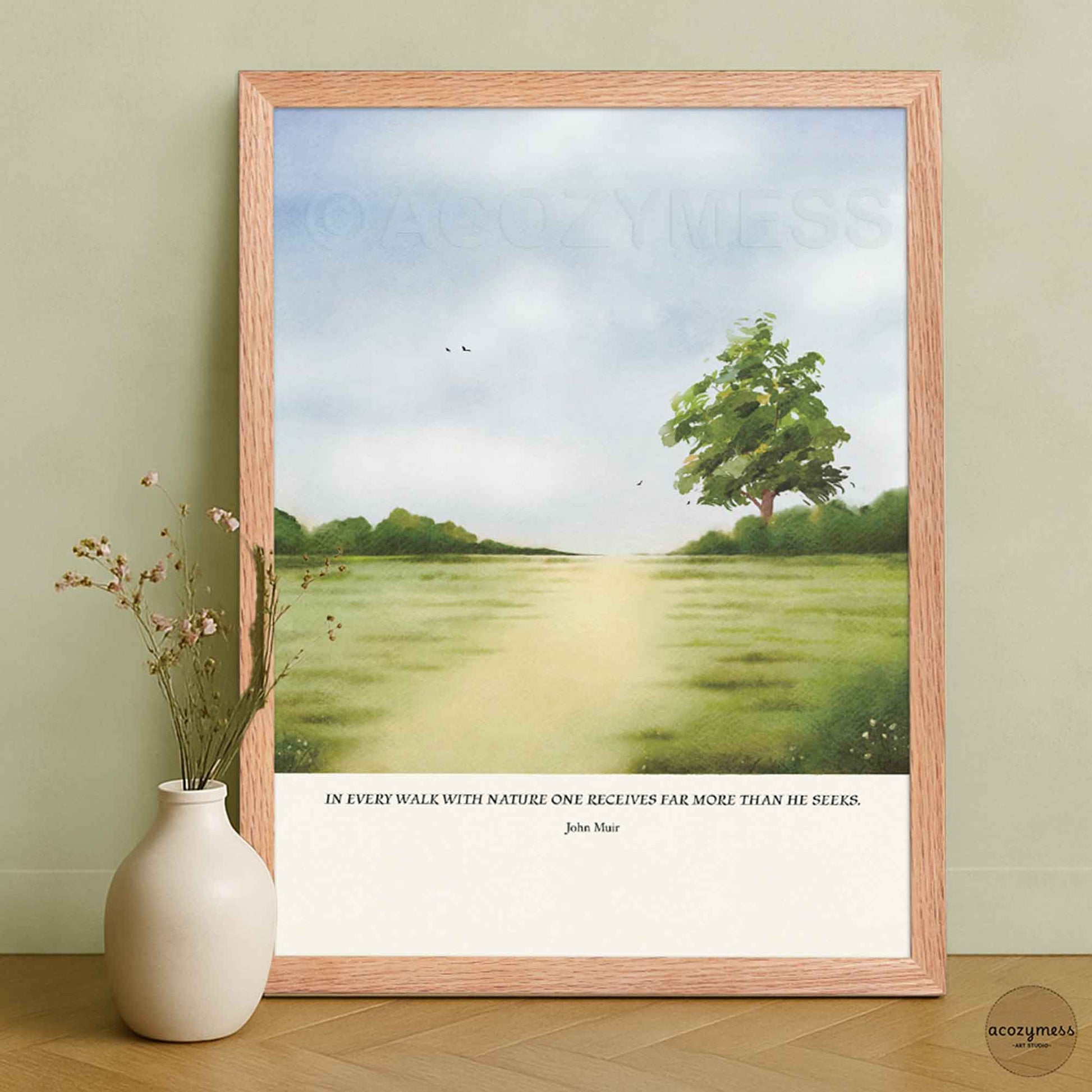 Inspirational nature quote wall art by John Muir presented in an oakwood frame, featuring a peaceful green landscape illustration.