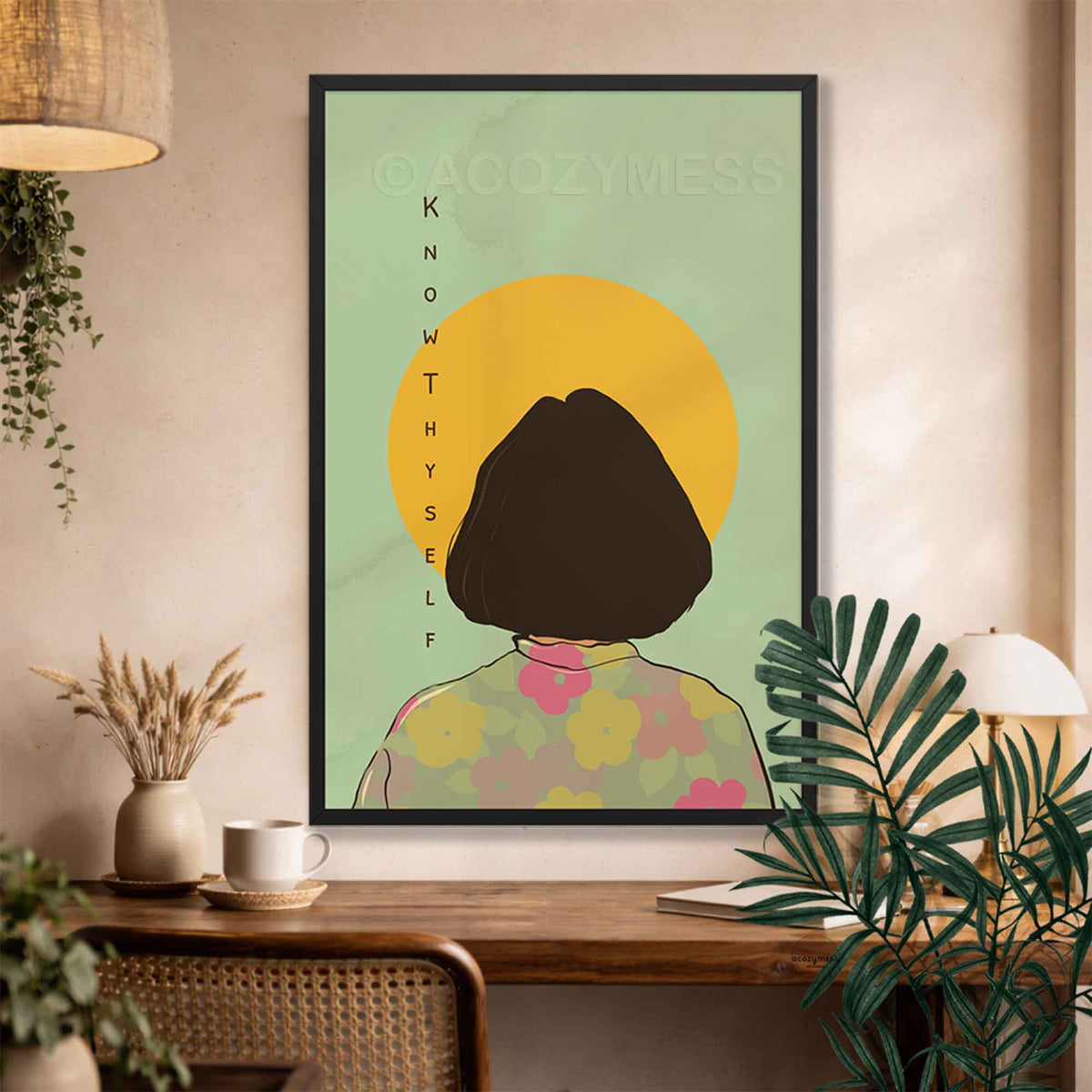 A black framed art print featuring a minimalist illustration of a person with a short dark bob haircut seen from behind, standing in front of a yellow sun on a pale green background. 
