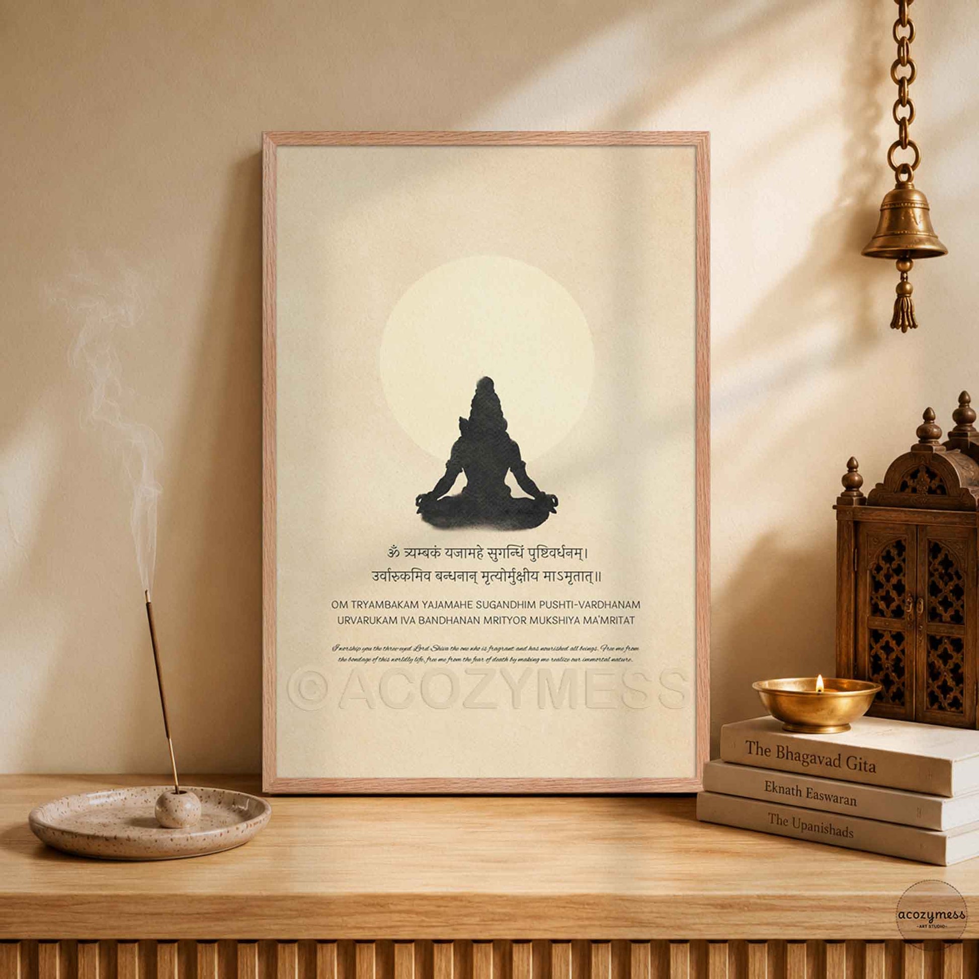 Framed minimalist Maha Mrityunjaya Mantra art print featuring a Lord Shiva meditation silhouette and English translation on a beige background for temple or puja room decor.