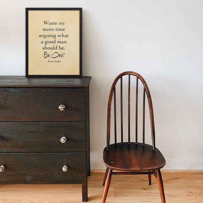 Black-on-beige literary print featuring the quote by Marcus Aurelius, styled with an old paper look and displayed in a black frame on a shelf adding a timeless and motivational touch to any space.