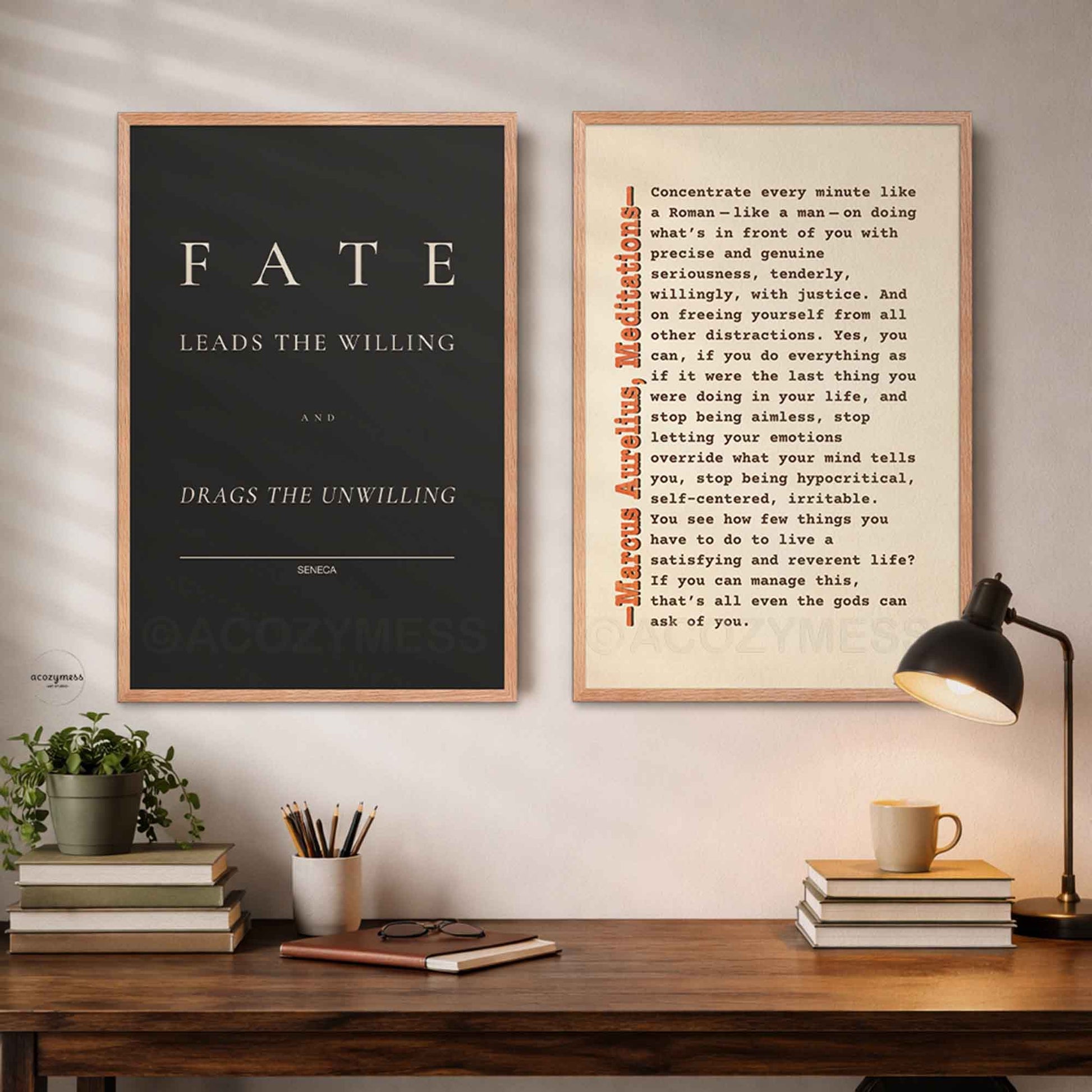 Two framed stoic quotes prints on a wall above a wooden desk.