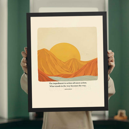 A motivational poster in black frame featuring Marcus Aurelius' quote, "The impediment to action advances action. What stands in the way becomes the way," alongside a nature illustration art.
