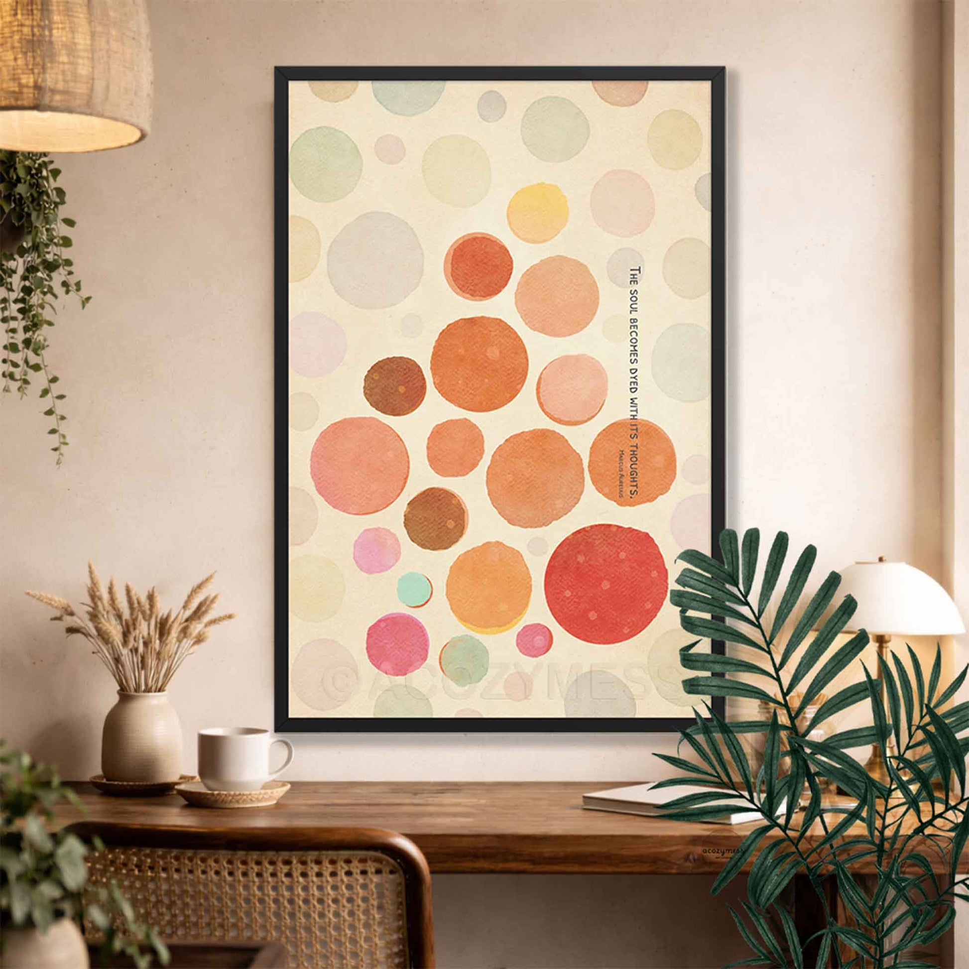 Black Framed abstract art print with colorful circles and Marcus Quote on a wall above a wooden console table.