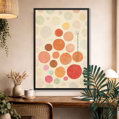 Black Framed abstract art print with colorful circles and Marcus Quote on a wall above a wooden console table.