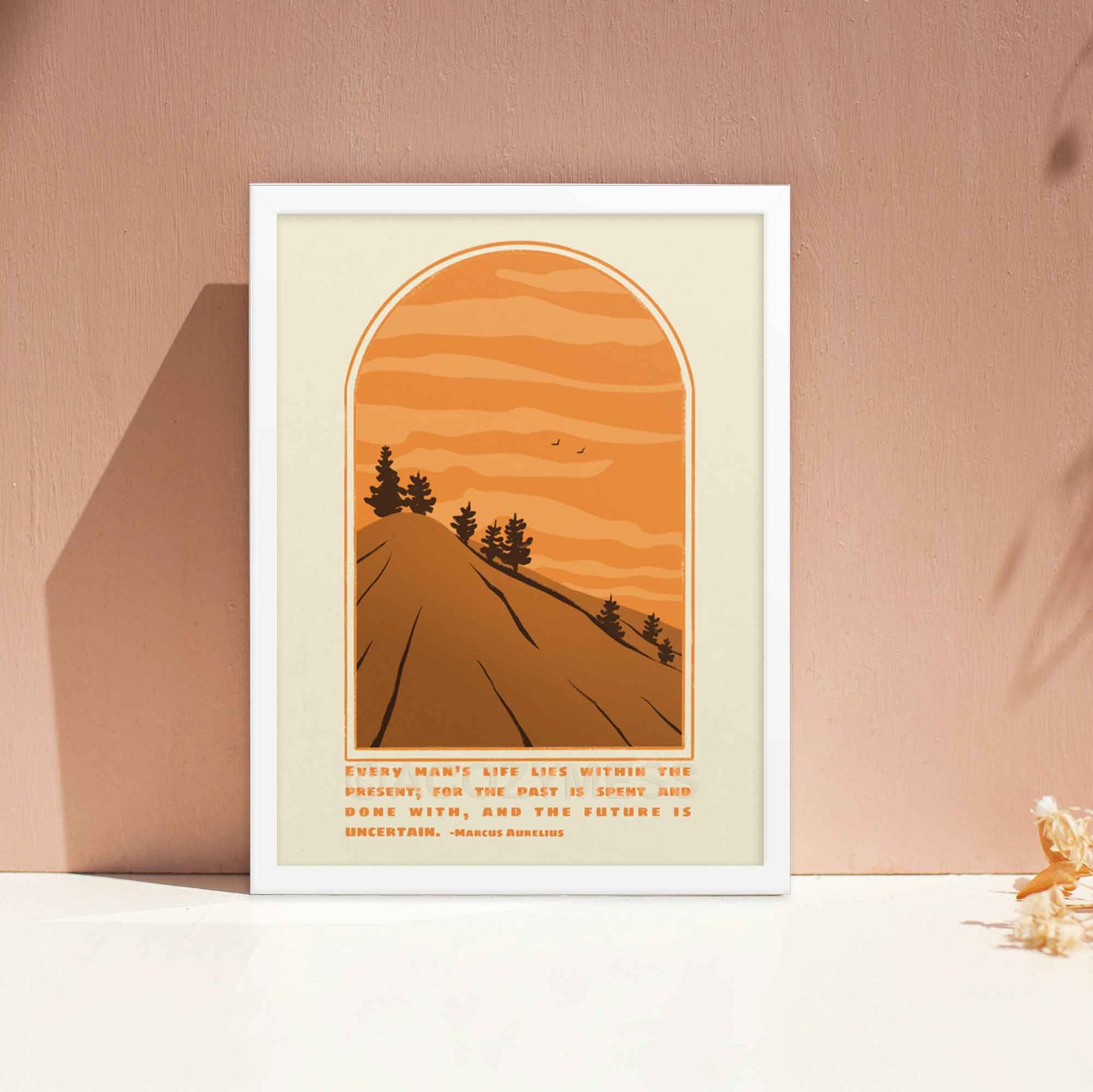 Marcus Aurelius Poster with quote on present moment with an illustration of a scenic mountain  view in beige, brown and orange colors displayed in white frame.