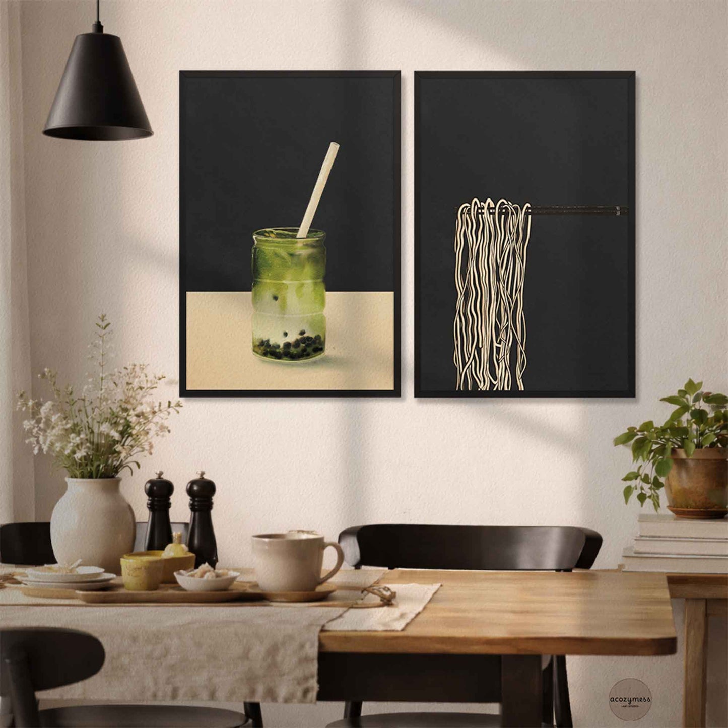 Dining room with black framed artwork on the wall, featuring a glass of matcha drink and noodles.